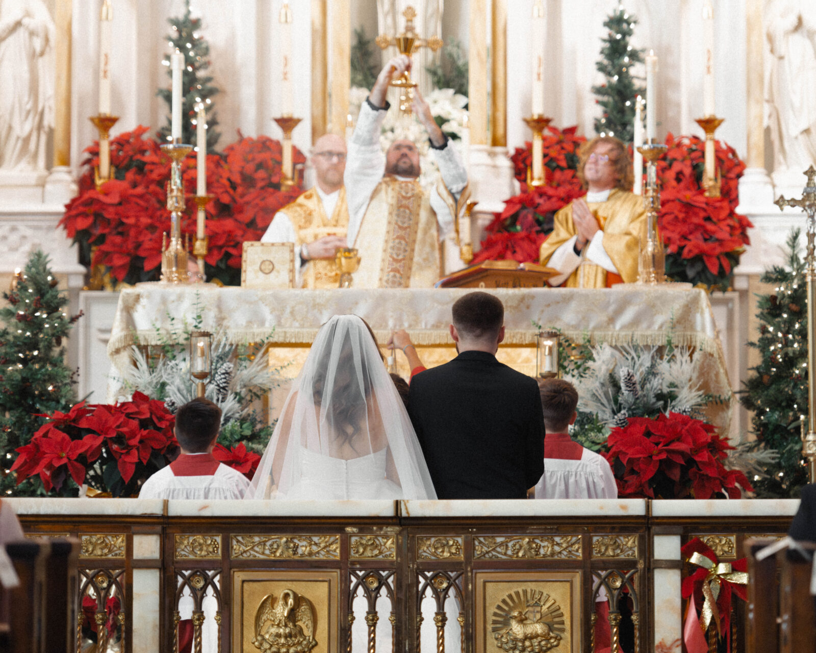 Image of the consecration of a Catholic Nuptial Mass with the chalice raised over the couple.