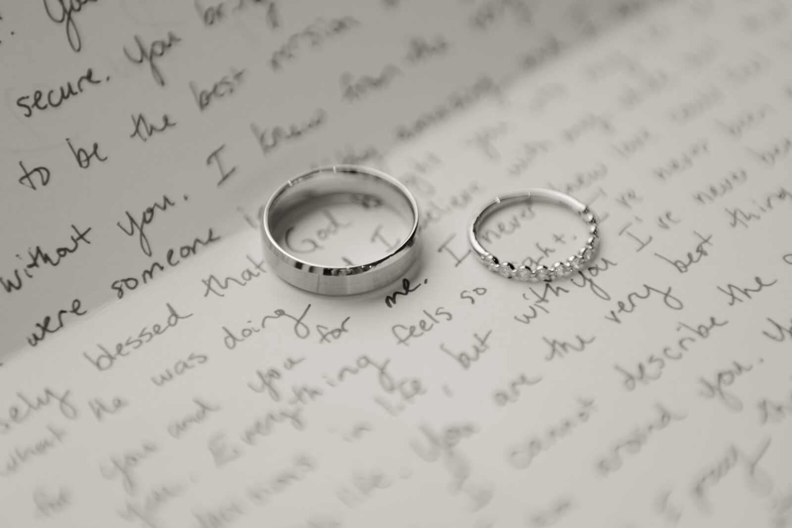 Two wedding bands on a hand written note to be exchanged between a bride and groom ahead of their Ohio Catholic Wedding.