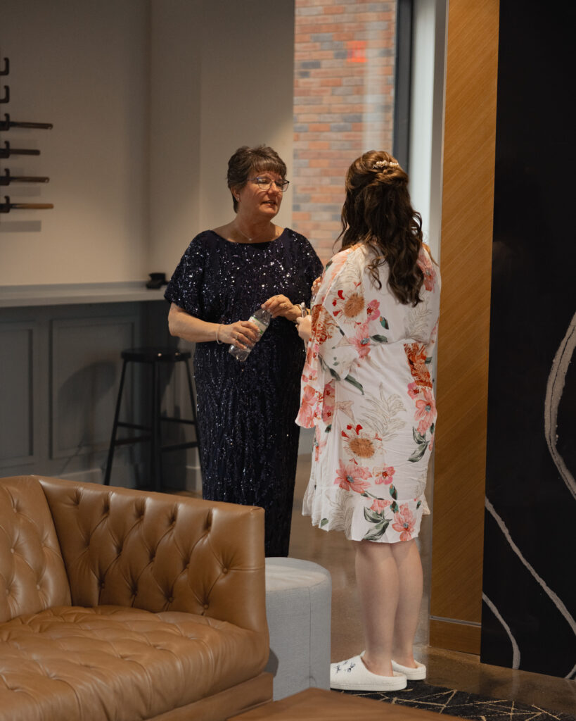 A Bride and her mom chat ahead of putting her wedding dress on for her Dayton Catholic wedding.