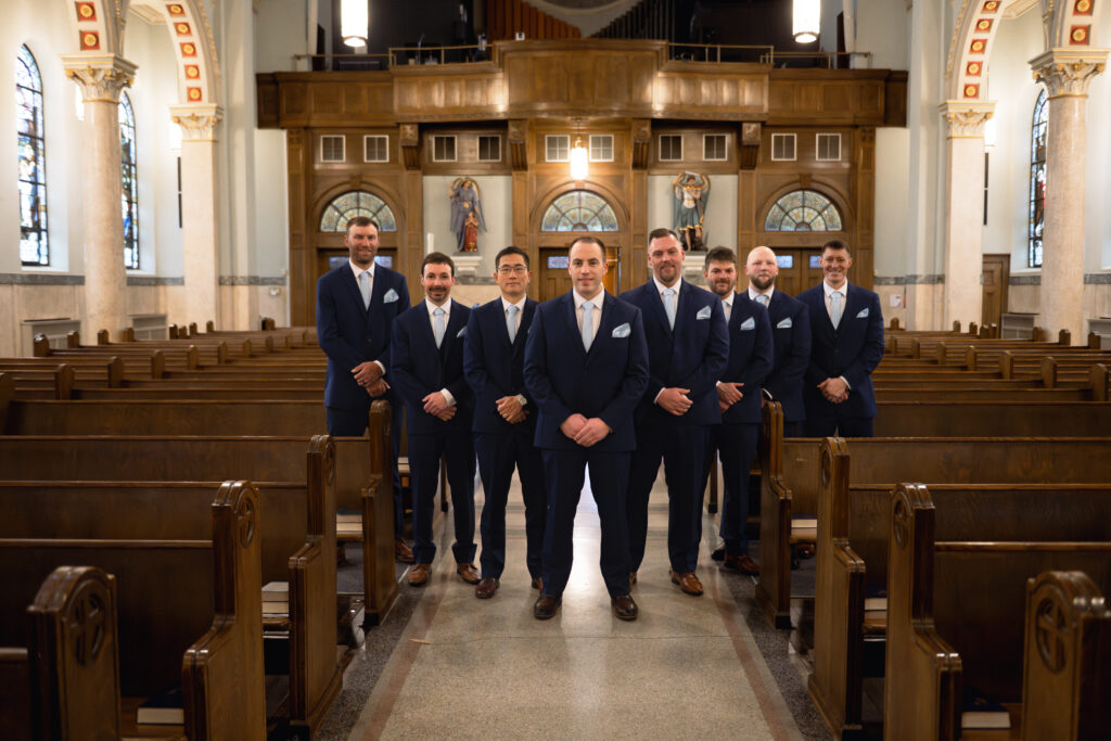 A groom and his groomsmen pose for a portrait inside Our Lady of the Rosary Catholic Church in downtown Dayton, Ohio.