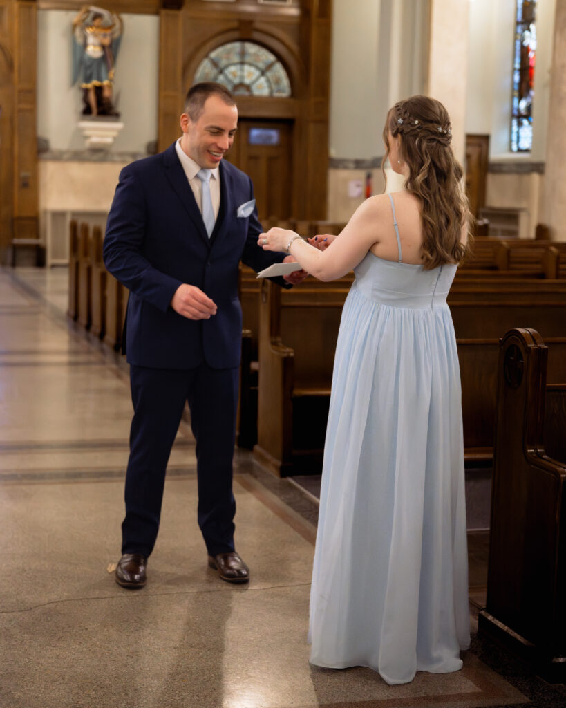 A groom exchanges letters with his bride via the maid of honor ahead of their ohio catholic wedding ceremony