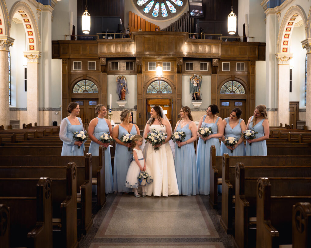 A bride and her bridesmaids pose for a portrait inside Our Lady of the Rosary Catholic Church in downtown Dayton, Ohio.