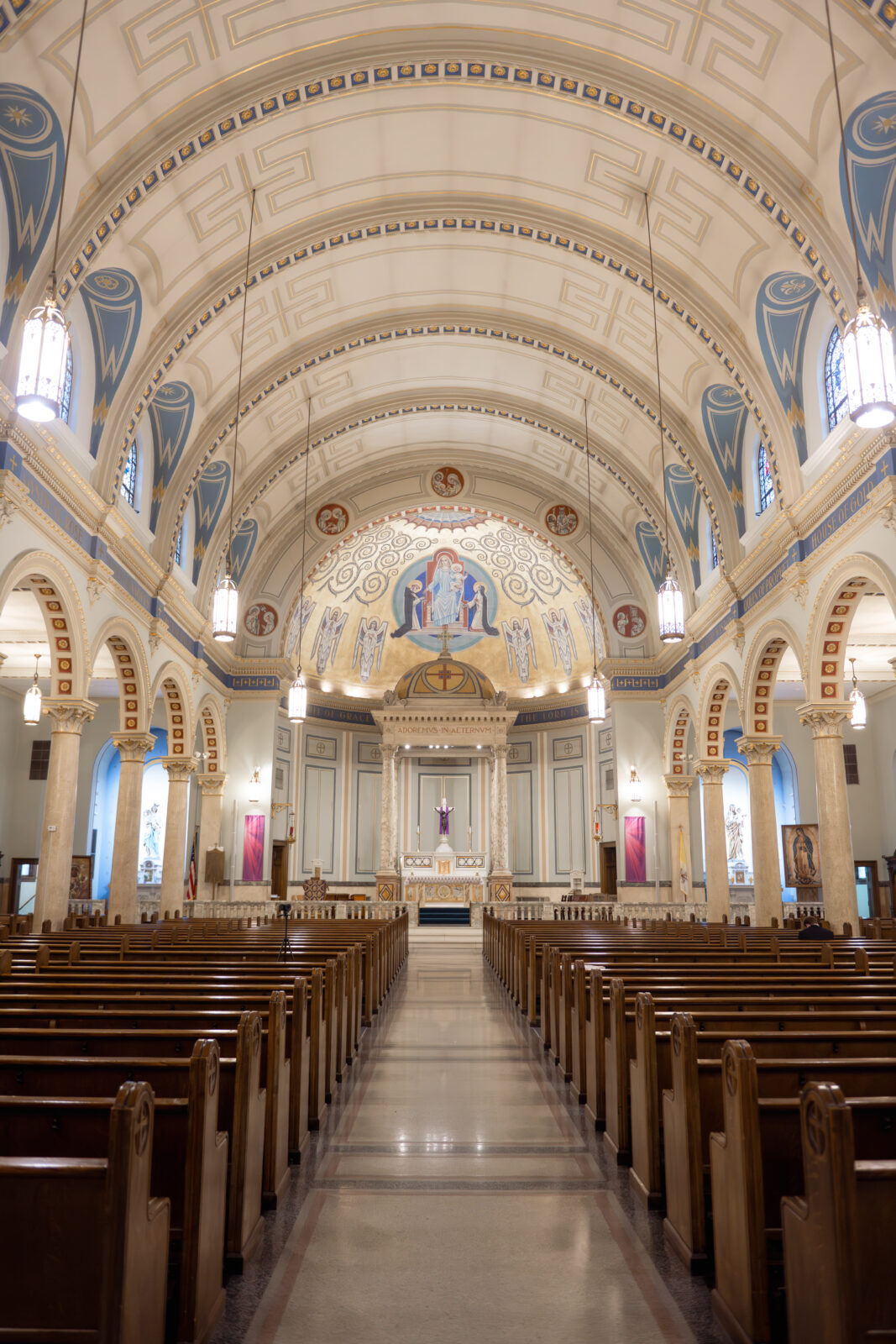 An empty view of the altar and aisle of Our Lady of the Rosary, a historic Catholic Church in downtown Dayton, Ohio ahead of a catholic wedding ceremony.