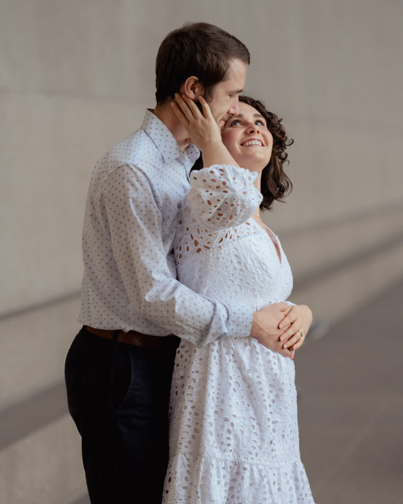 A catholic bride gazes lovingly at her groom during their engagement session at centennial park in nashville, TN