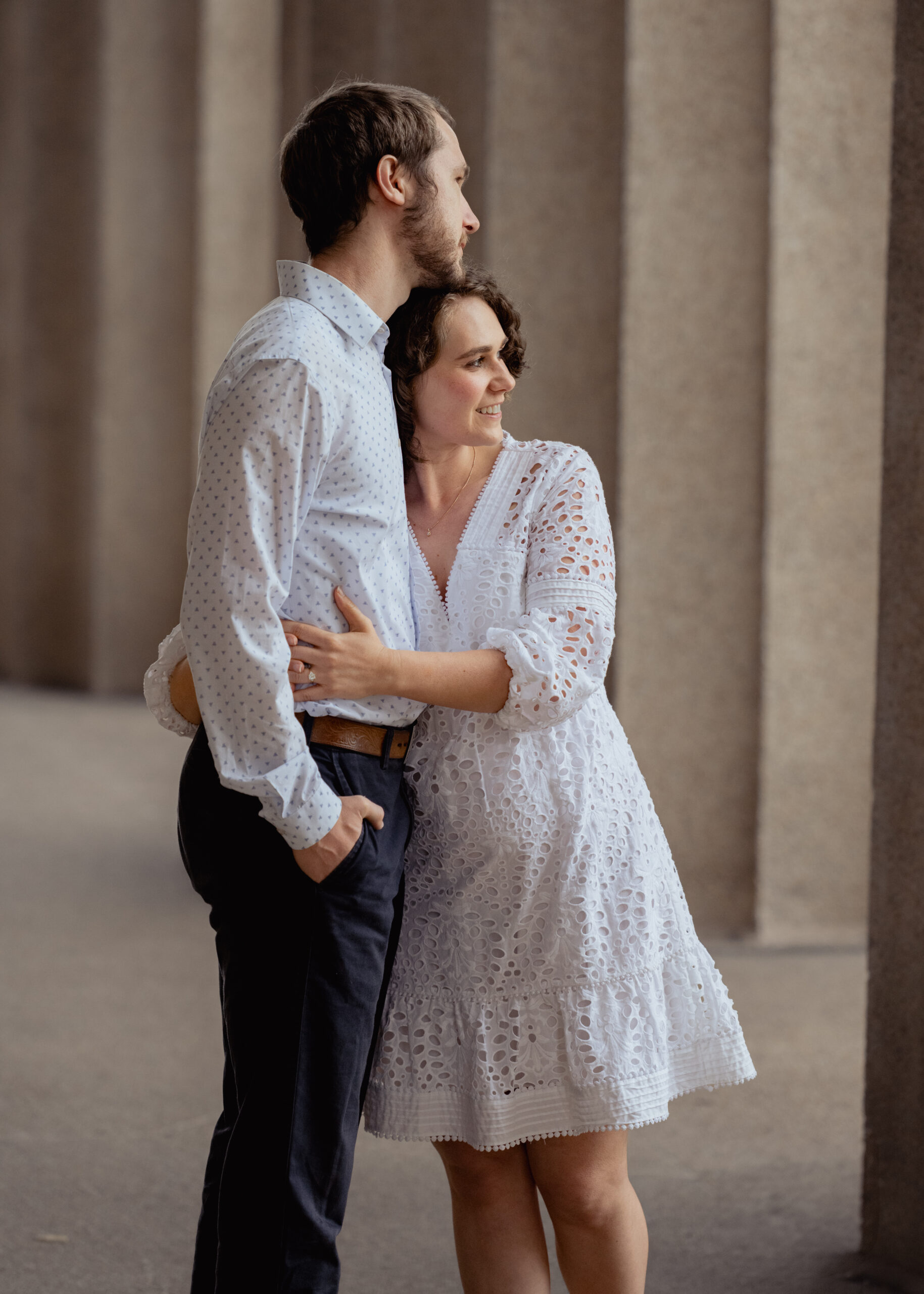 A catholic bride and groom spend an moment embracing during their relaxed engagement session at centennial park in nashville, tn