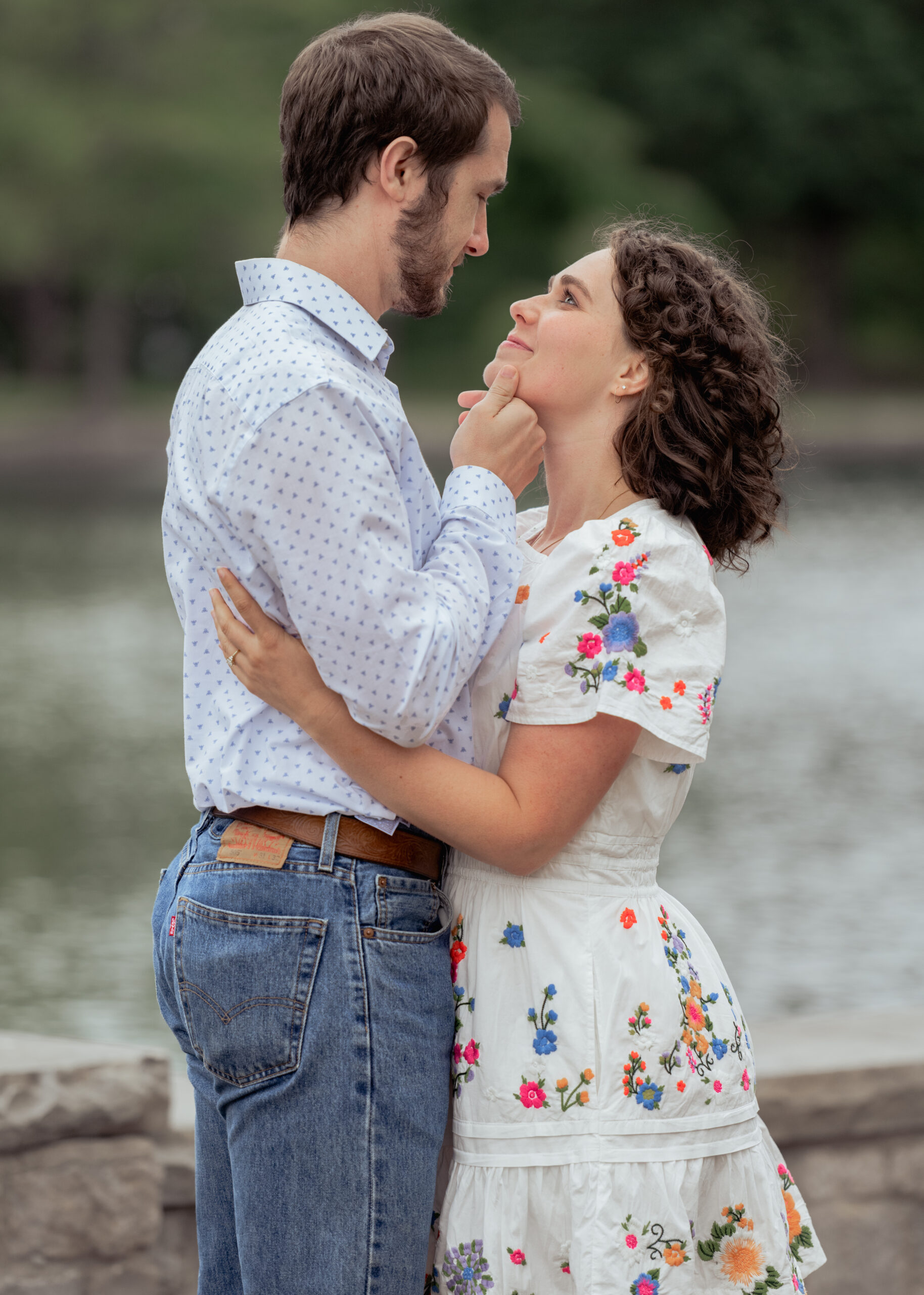 A catholic bride and groom stare lovingly into each other's eyes during their catholic engagement session at centennial park in nashville, tn
