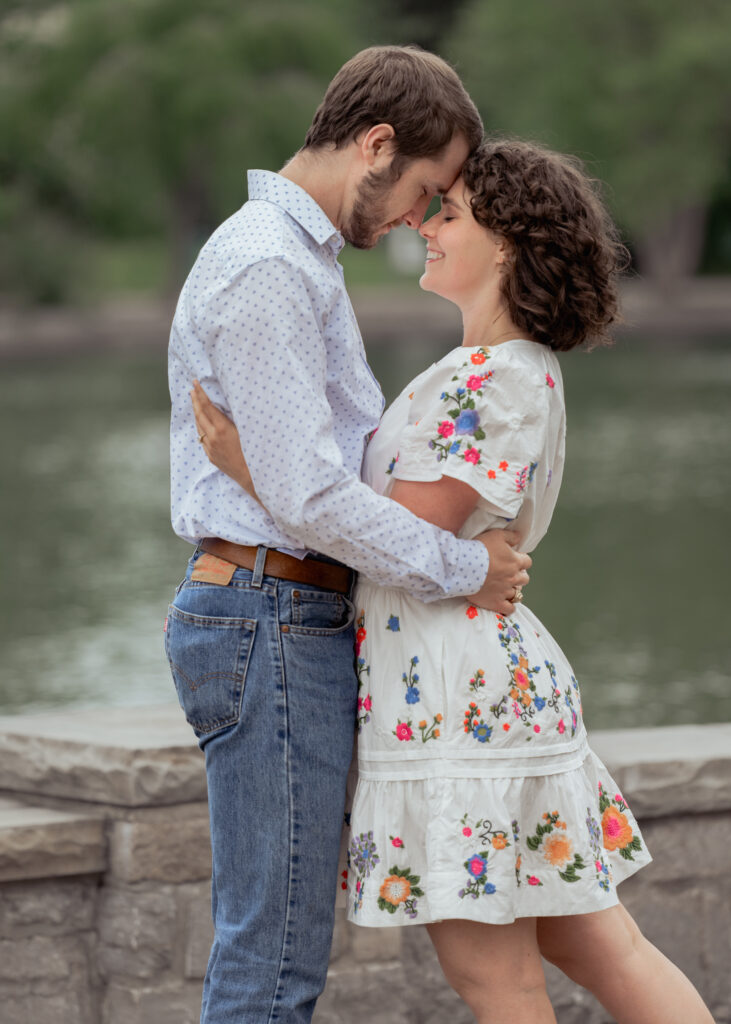 A catholic bride and groom share an intimate moment during their engagement session at centennial park in nashville, tn