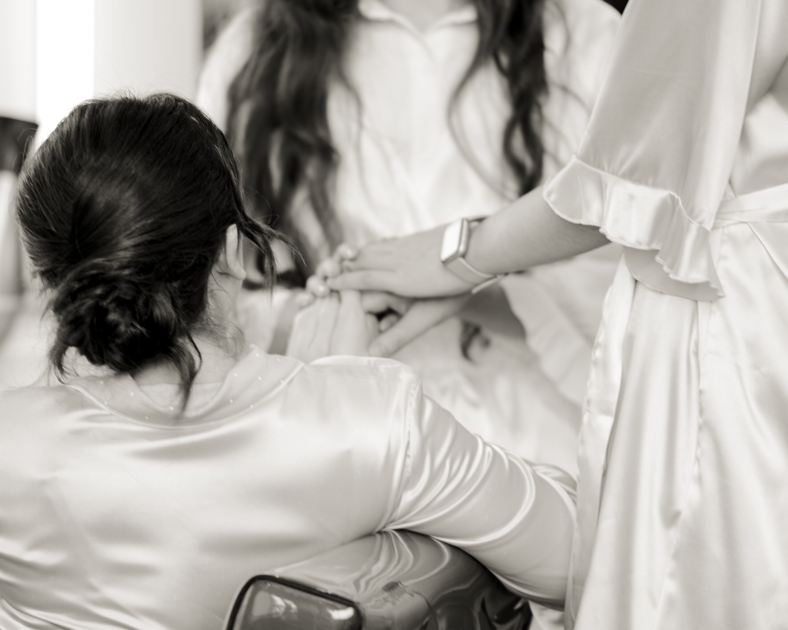 A detail photograph of catholic bridesmaids getting ready for a nashville wedding at the Blowout co. in downtown nashville.