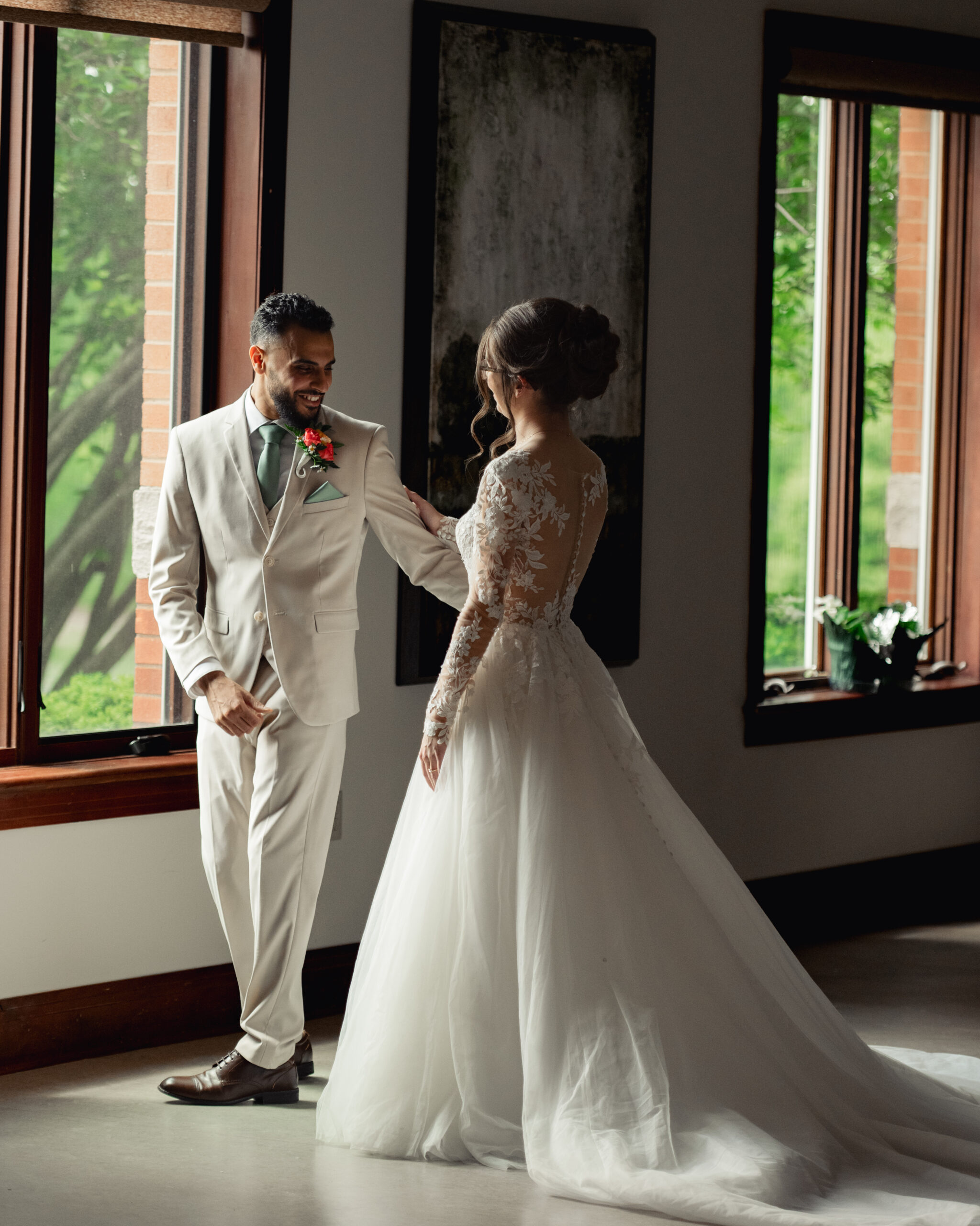 A bride and groom share a first look at Holy Family catholic church in Nashville ahead of their catholic wedding Mass.