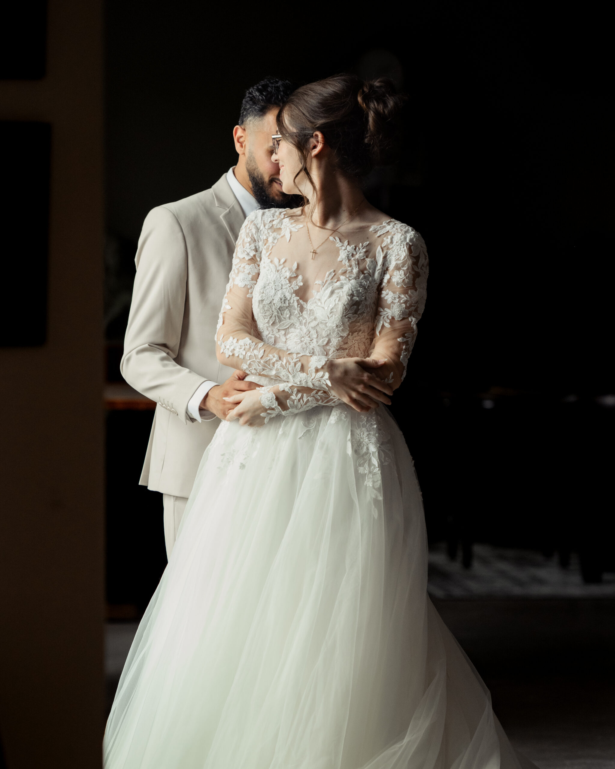 A bride and groom share an intimate moment during their first look at Holy Family catholic church in Nashville ahead of their catholic wedding Mass.