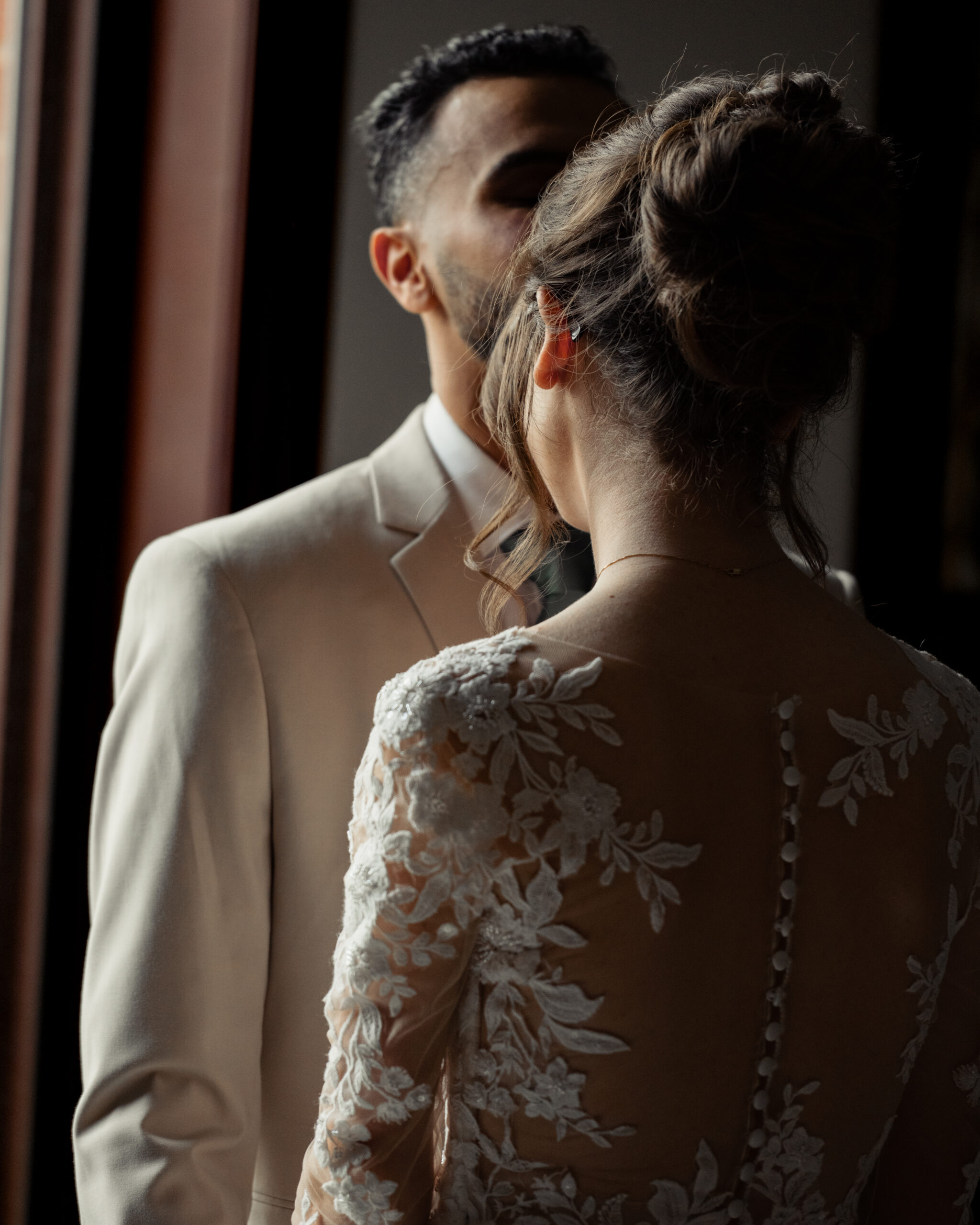 A bride and groom share an intimate moment during their first look at Holy Family catholic church in Nashville ahead of their catholic wedding Mass.