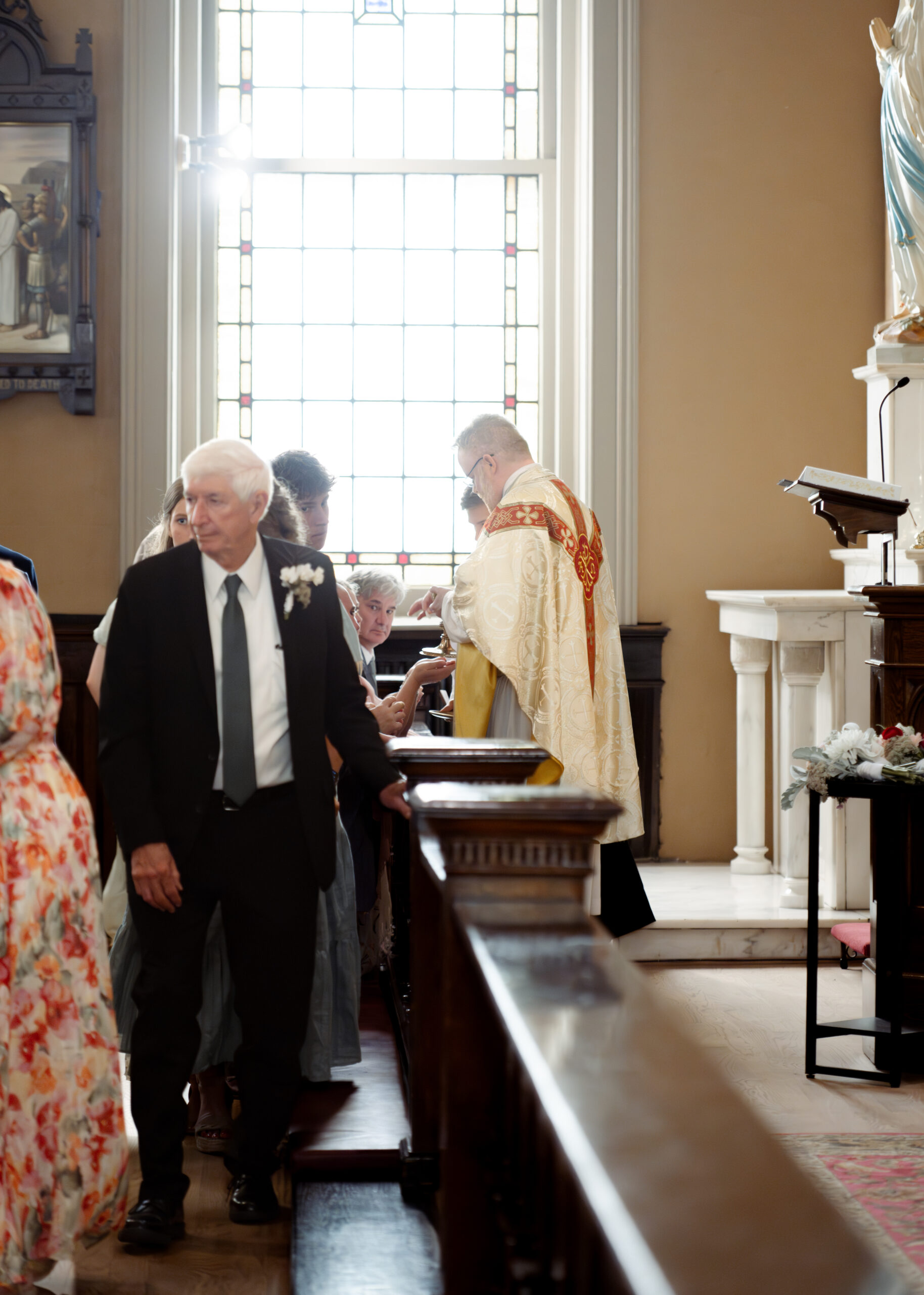 Wedding guests receive communion during a catholic wedding Mass at St. Mary's of the Seven sorrows in downtown Nashville, tn
