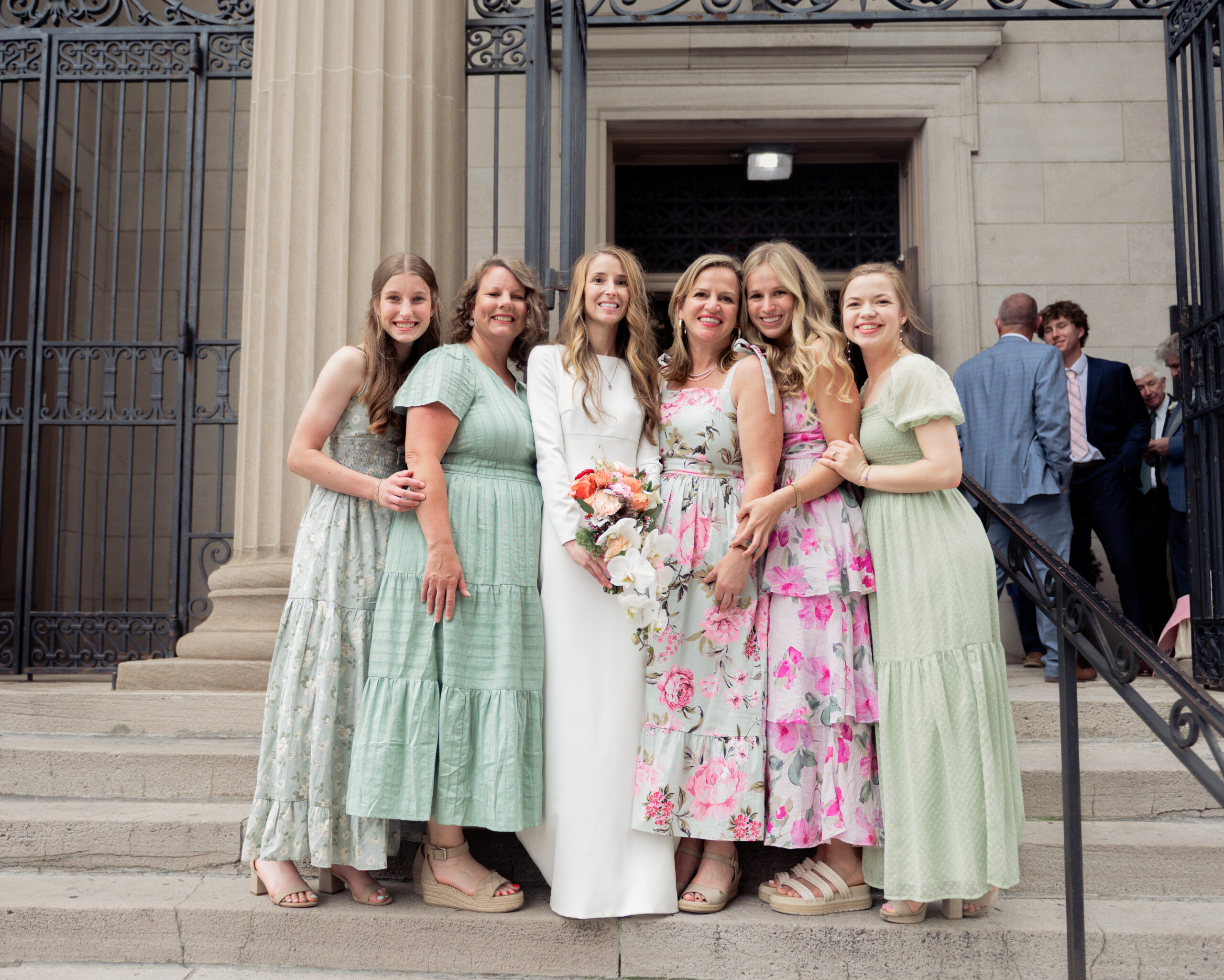 A catholic bride and some of her family take a photograph together on the steps of St. Mary's of the Seven sorrows in downtown Nashville, tn