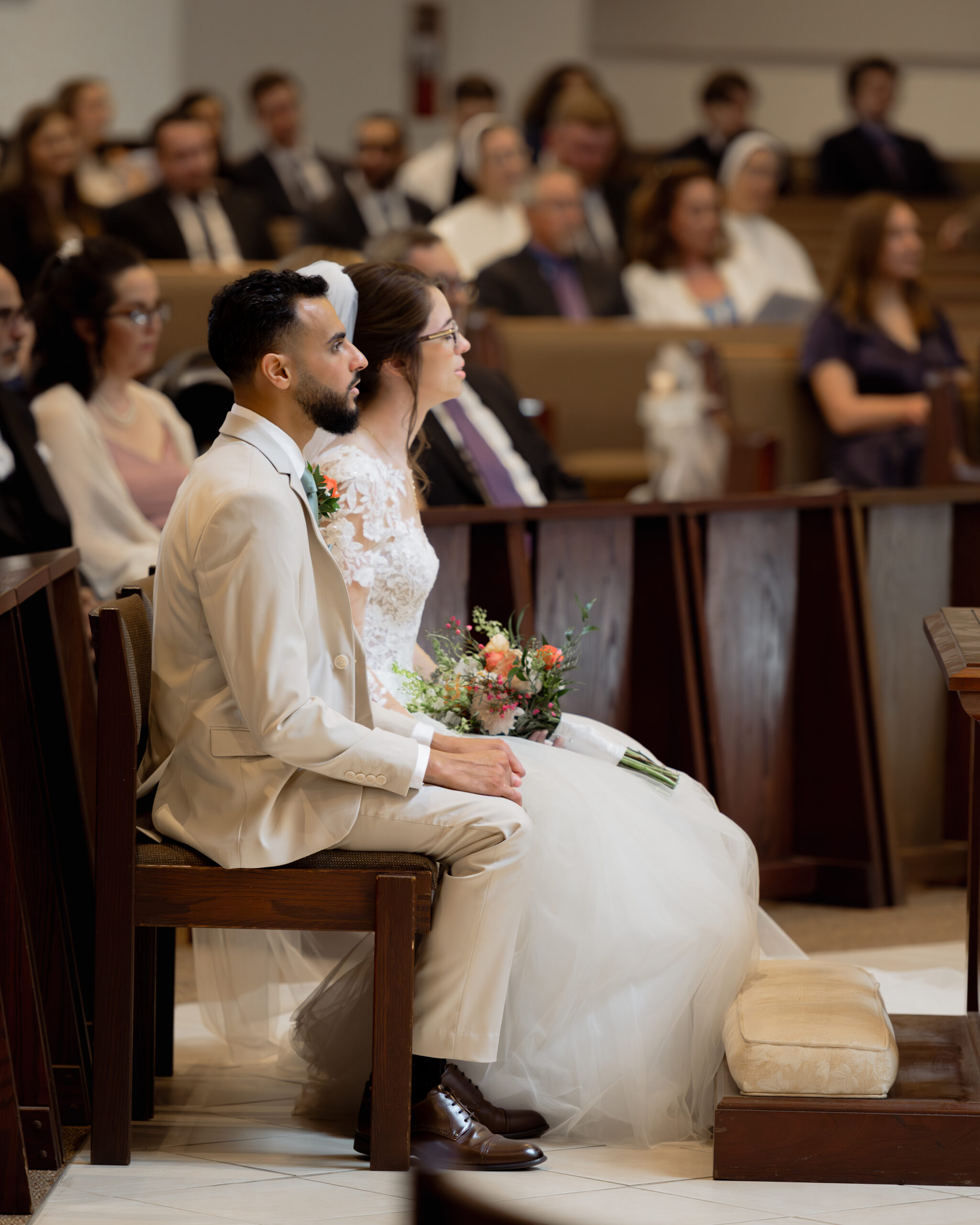 A bride and groom pray together during a catholic wedding Mass at Holy Family Catholic Church in Brentwood, TN.