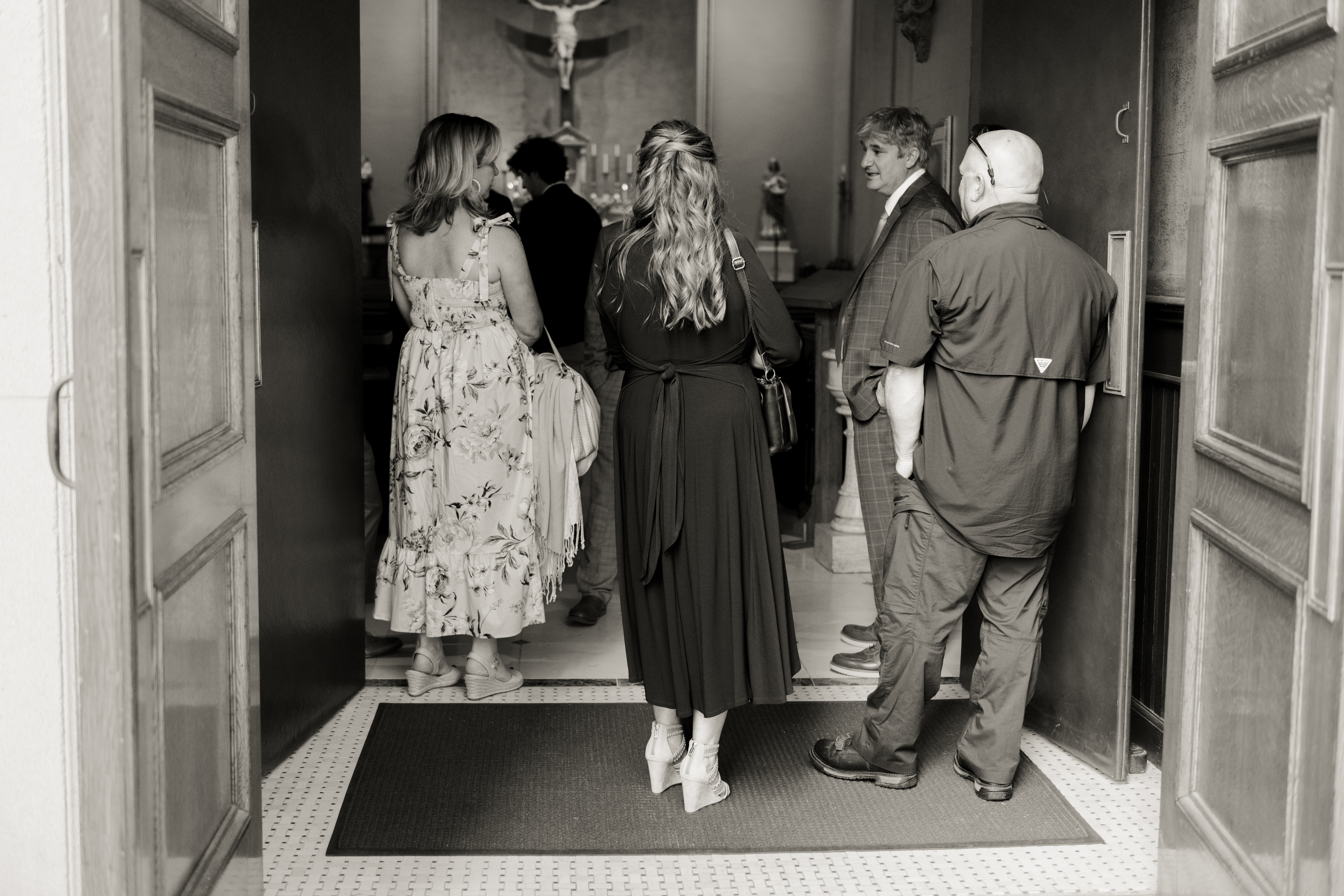 Extended family socializes outside of St. Mary's of the Seven sorrows in downtown Nashville, tn after a catholic wedding Mass