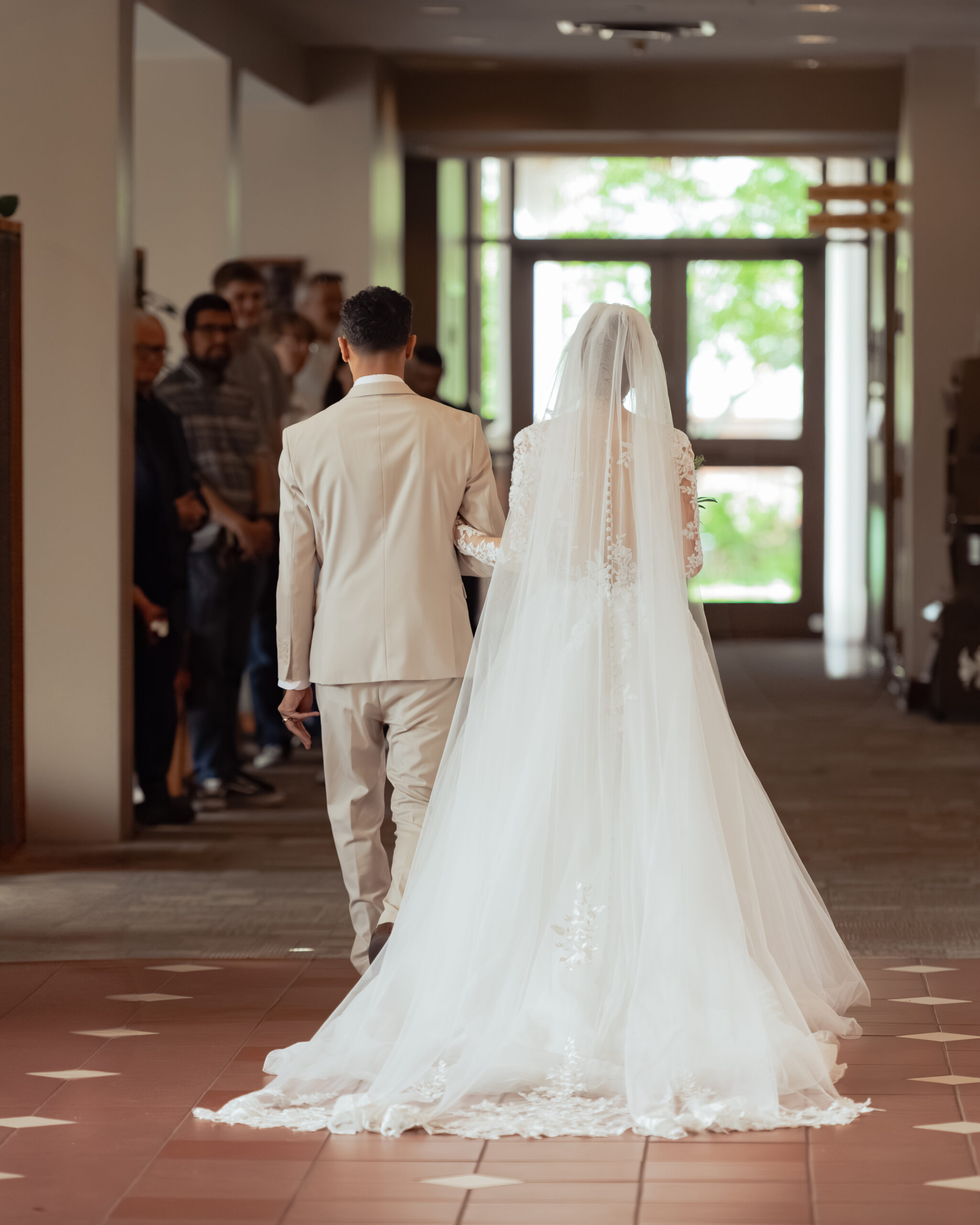 A catholic bride and groom walk away after their nashville catholic wedding mass at holy family catholic church in brentwood
