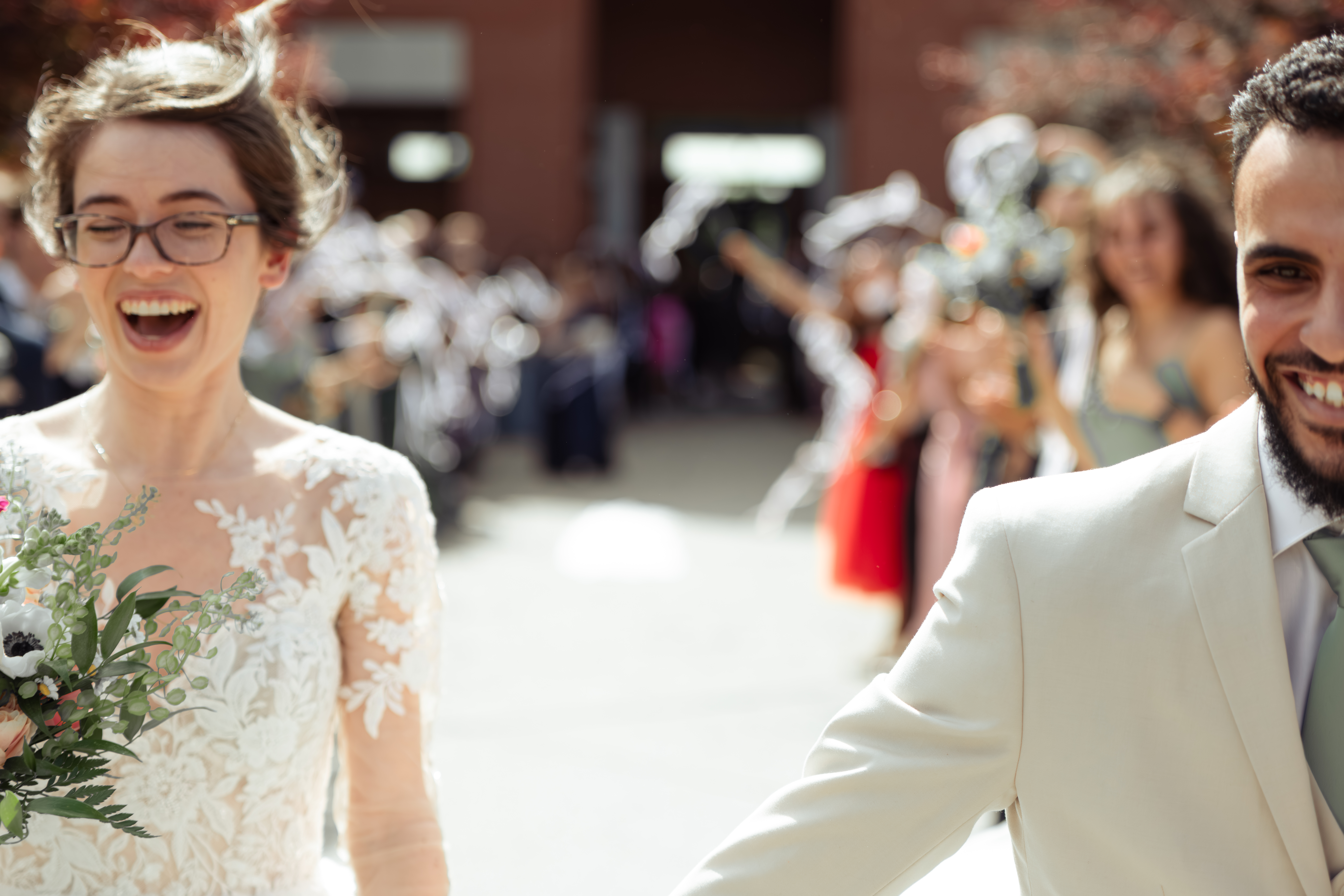 a catholic bride and groom joyfully run away during their traditional church exit outside of holy family catholic church in brentwood, tennessee