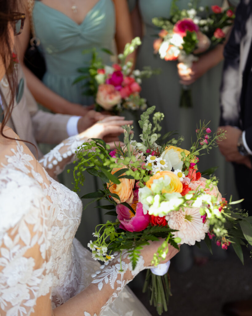 A colorful bridal bouquet from brentwood flower shoppe brightens up a catholic wedding mass in brentwood tennessee.