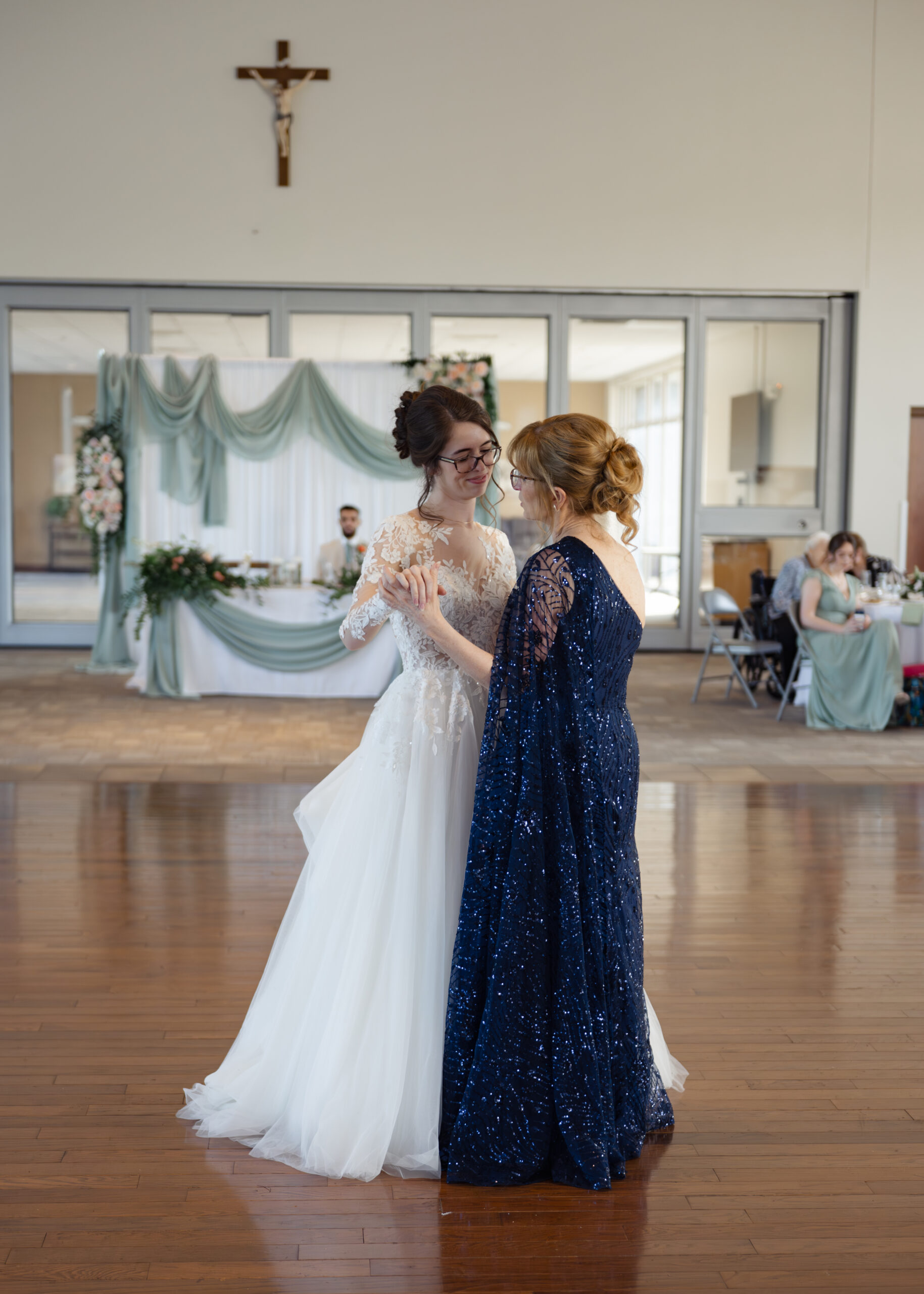 The bride and her mother share a tearful dance at a catholic wedding reception at holy family catholic church in brentwood, tn
