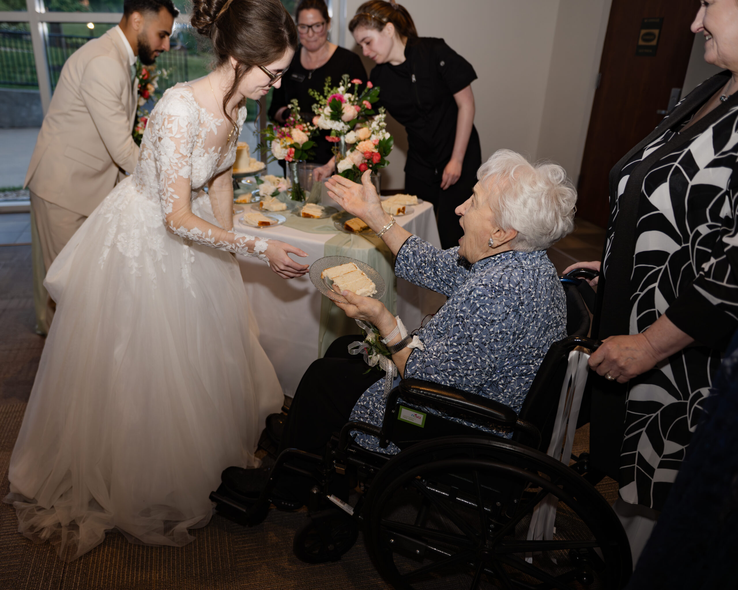 A catholic bride gives her joyful grandmother some cake at A catholic bride and groom share an intimate moment cutting cake at a catholic wedding reception at holy family catholic church in brentwood, tn