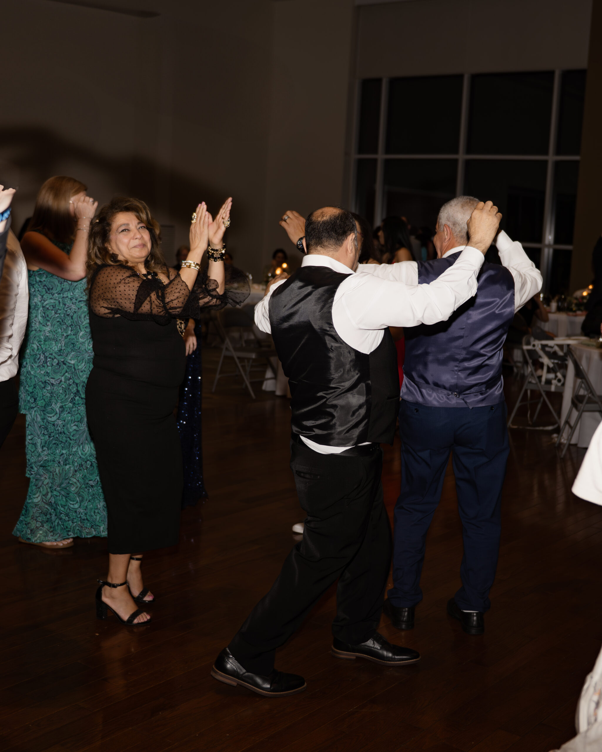 Wedding guests dance at a catholic wedding reception at holy family catholic church in brentwood, tn