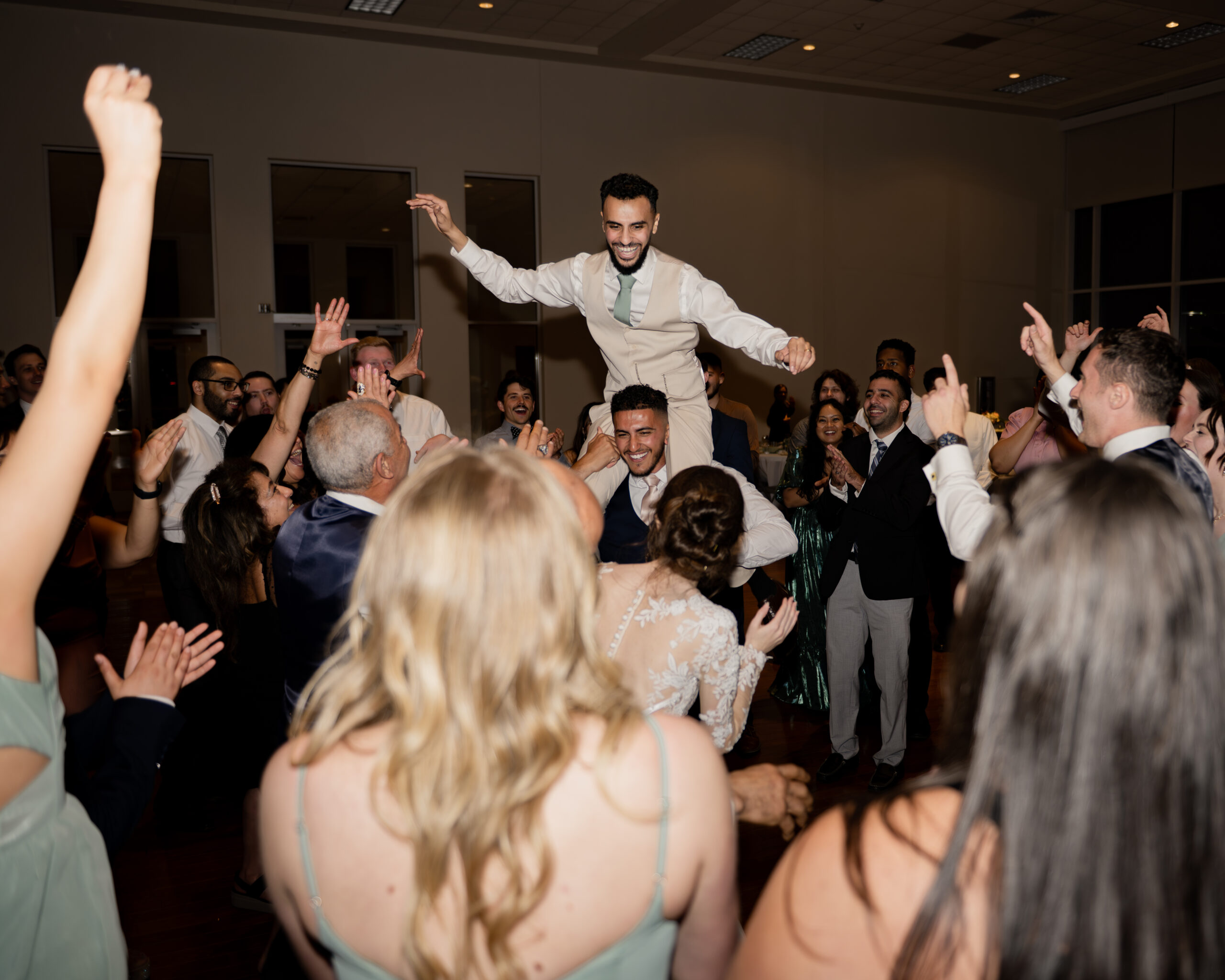 Wedding guests dance at a catholic wedding reception at holy family catholic church in brentwood, tn