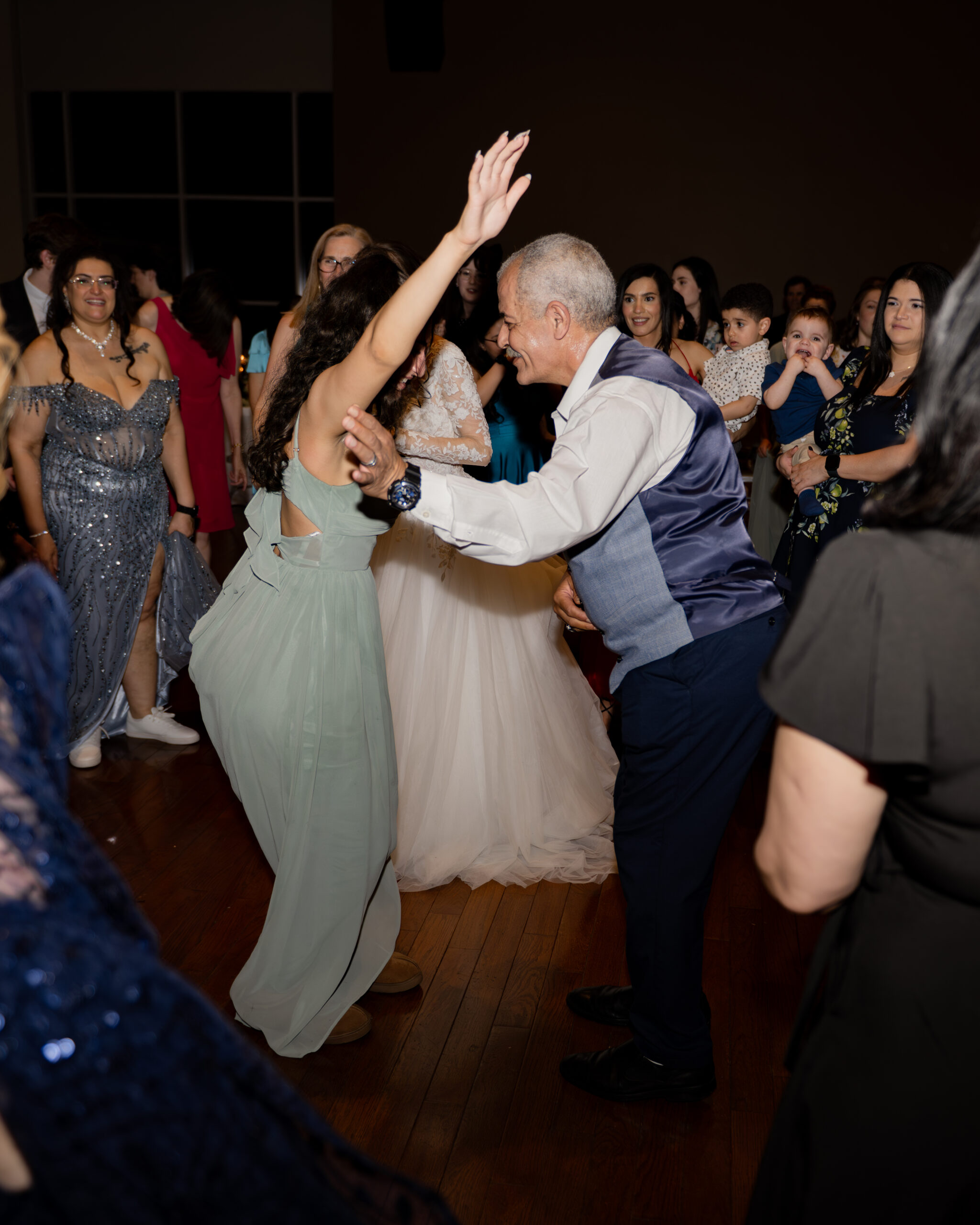 Wedding guests dance at a catholic wedding reception at holy family catholic church in brentwood, tn
