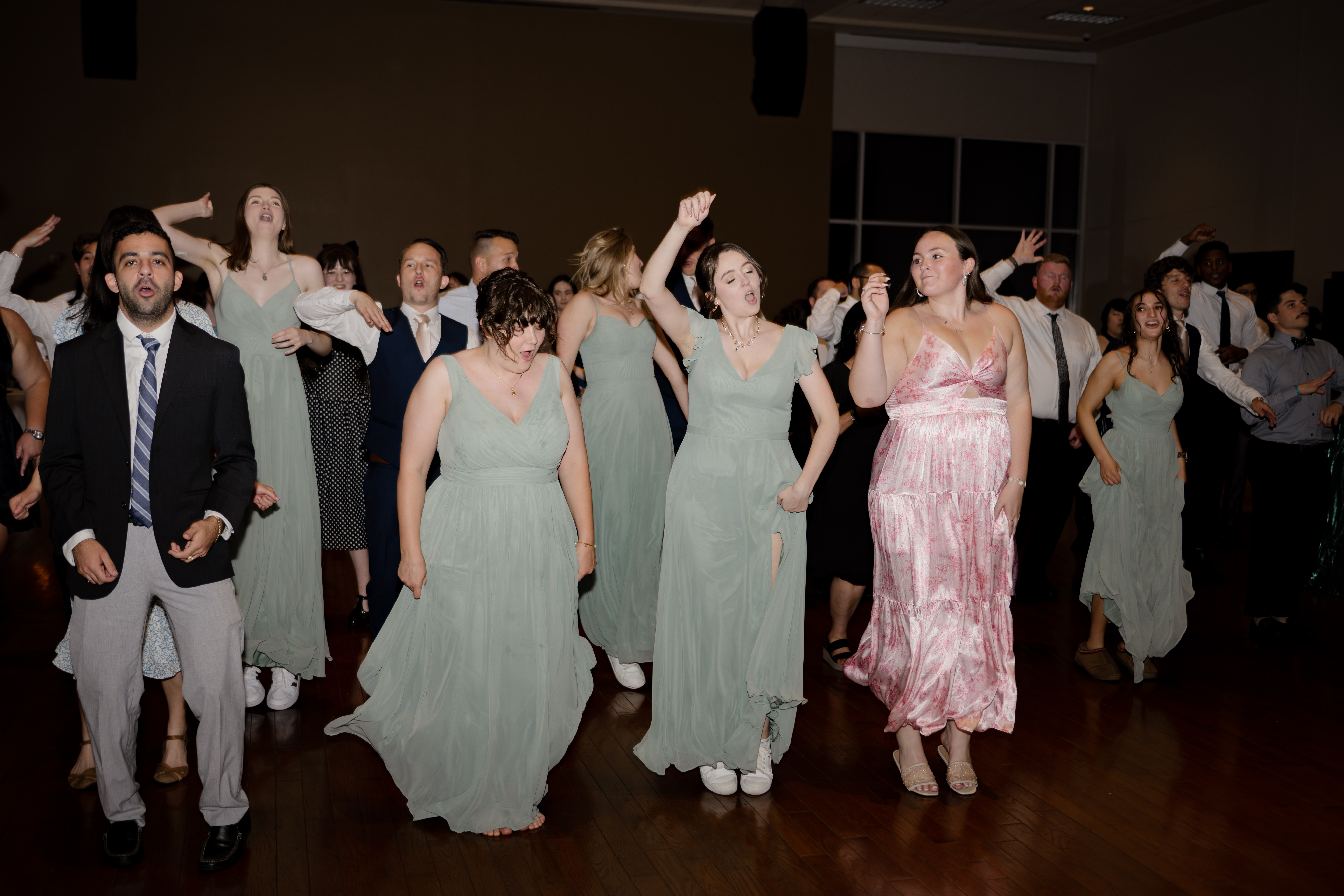 Wedding guests dance at a catholic wedding reception at holy family catholic church in brentwood, tn