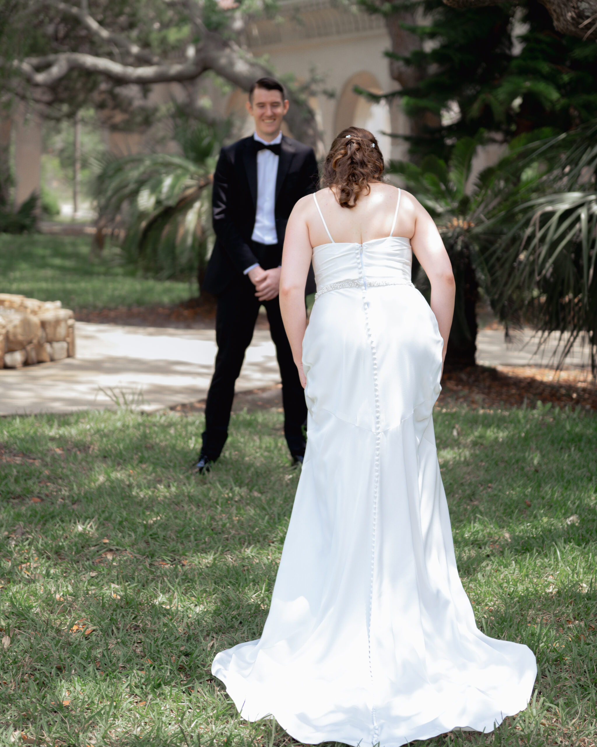 A catholic bride and groom share a first look at st anastasia's catholic church head of their wedding mass in st. augustine, florida