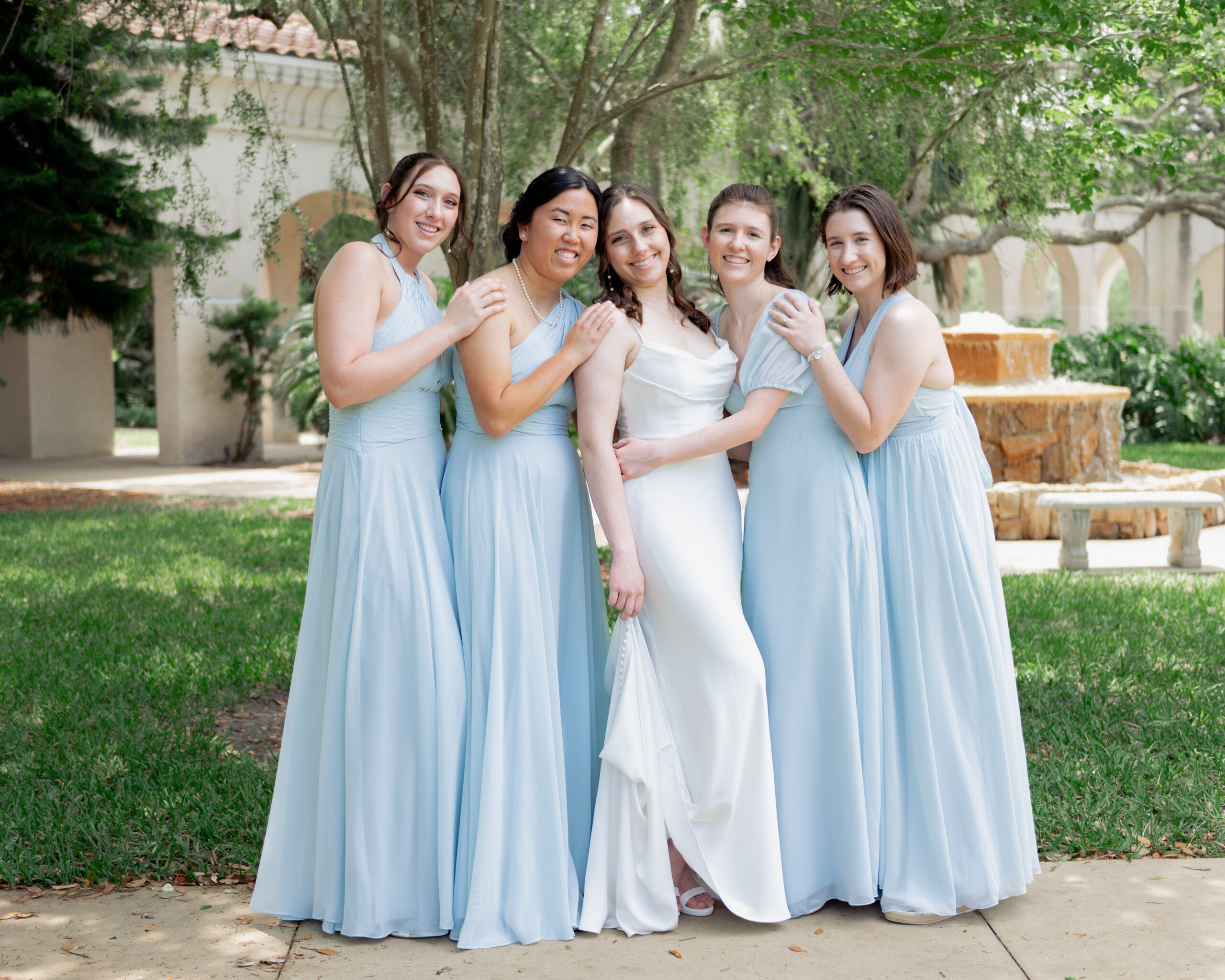 bridesmaids hug a catholic bride ahead of her wedding mass in st augustine florida