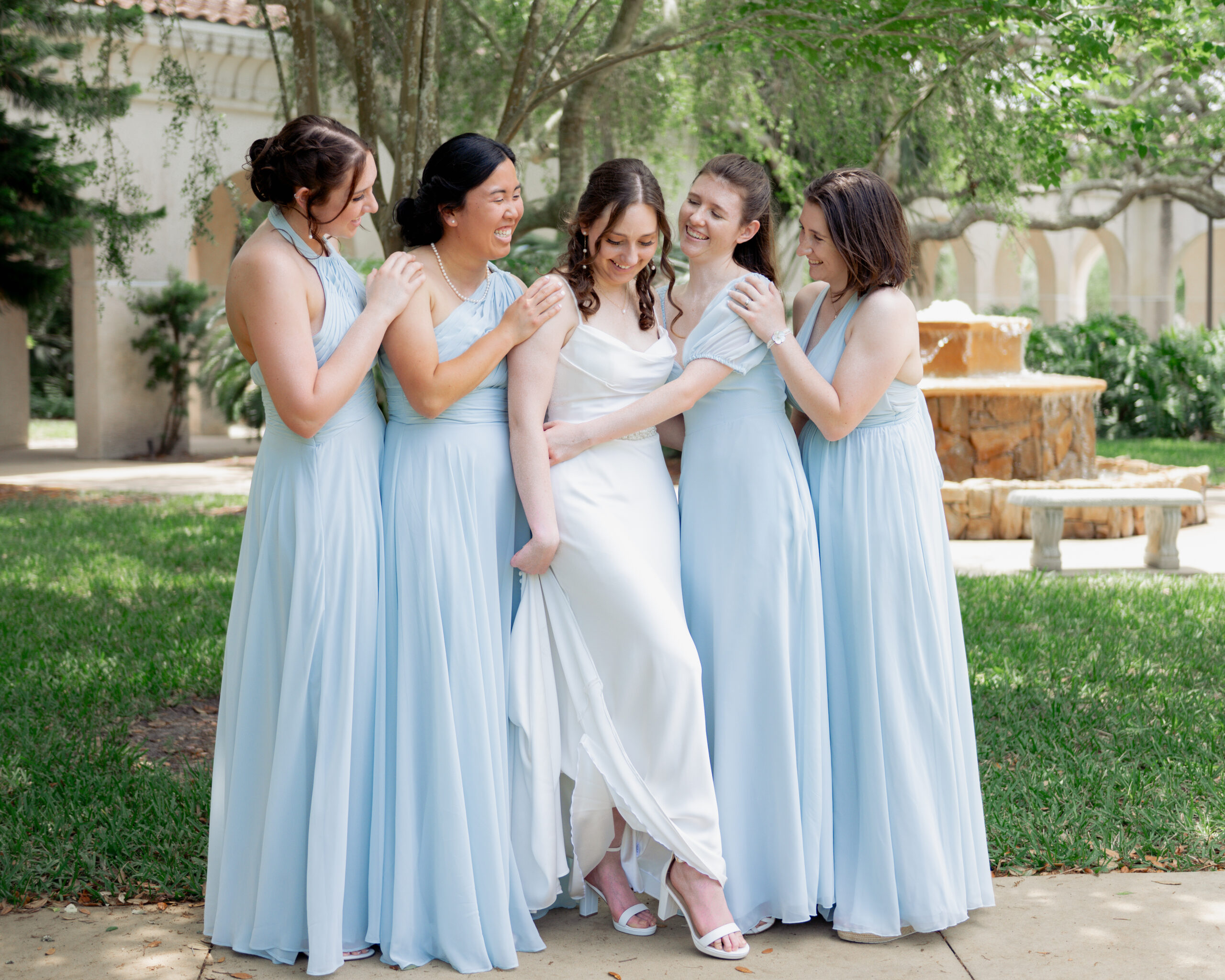 bridesmaids hug a catholic bride ahead of her wedding mass in st augustine florida