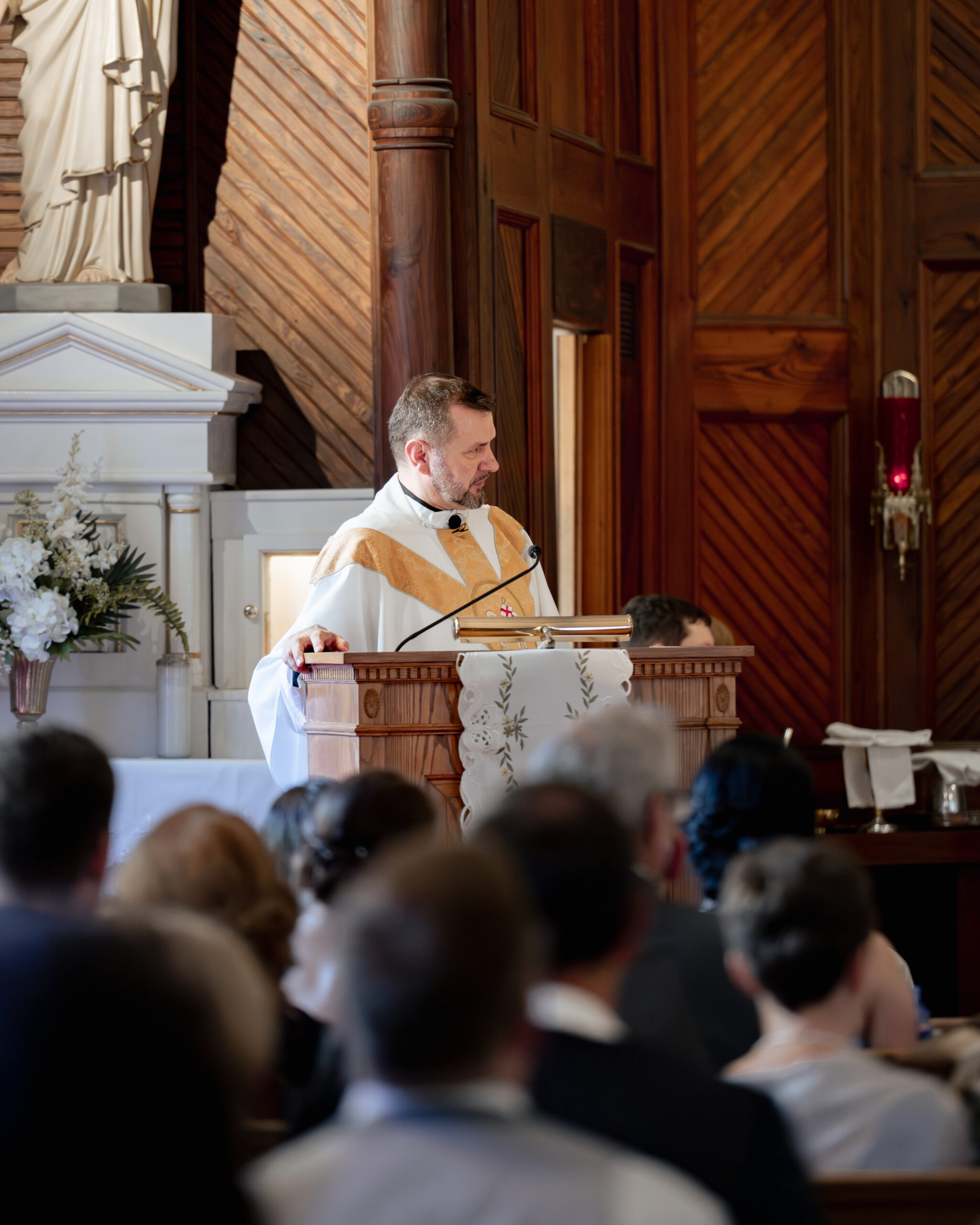 a catholic priest gives a homily during a catholic wedding Mass at st. ambrose Catholic church in st. augustine florida