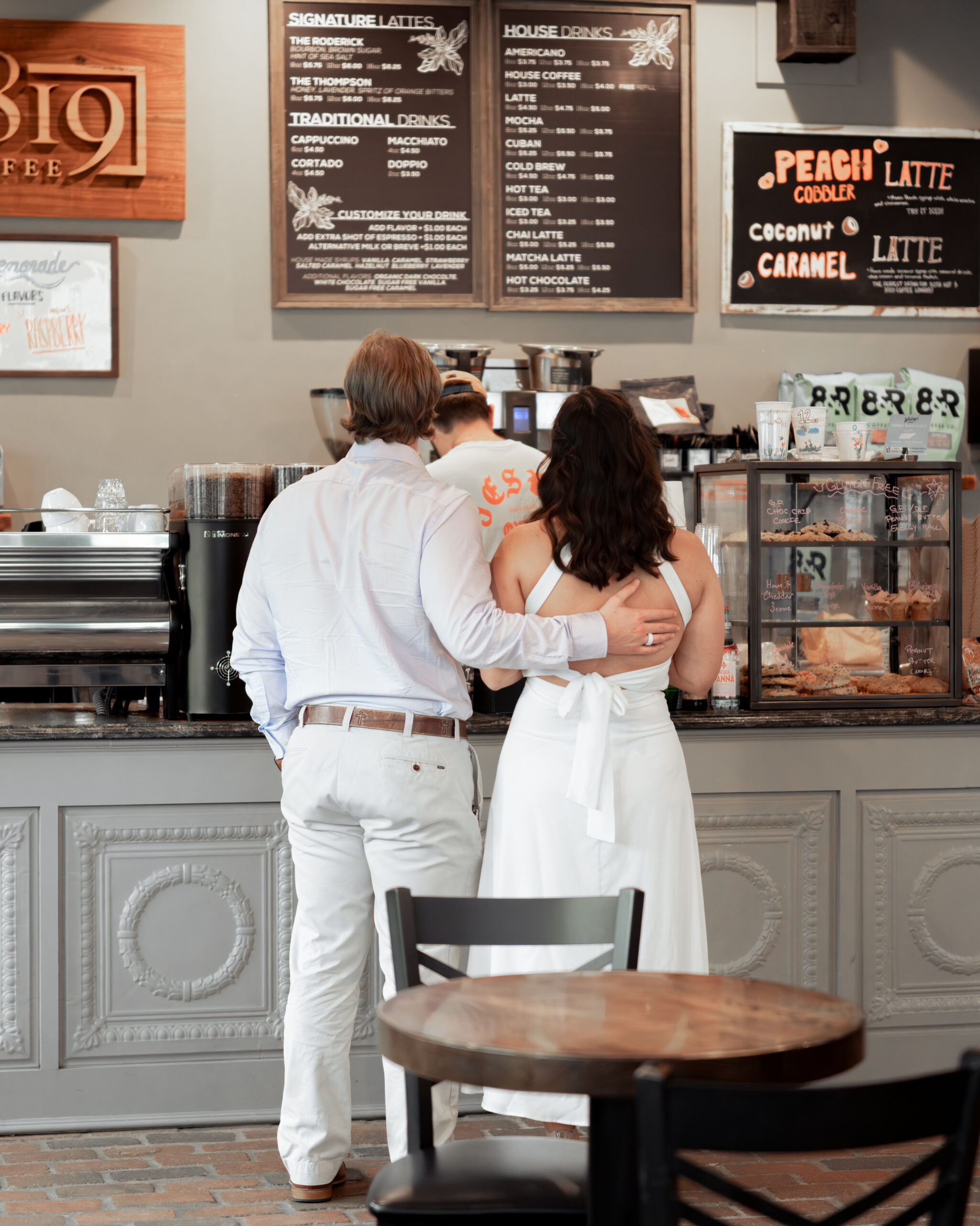 A catholic couple orders coffee ahead of their tennessee engagement session, setting the scene for a cozy portrait session.