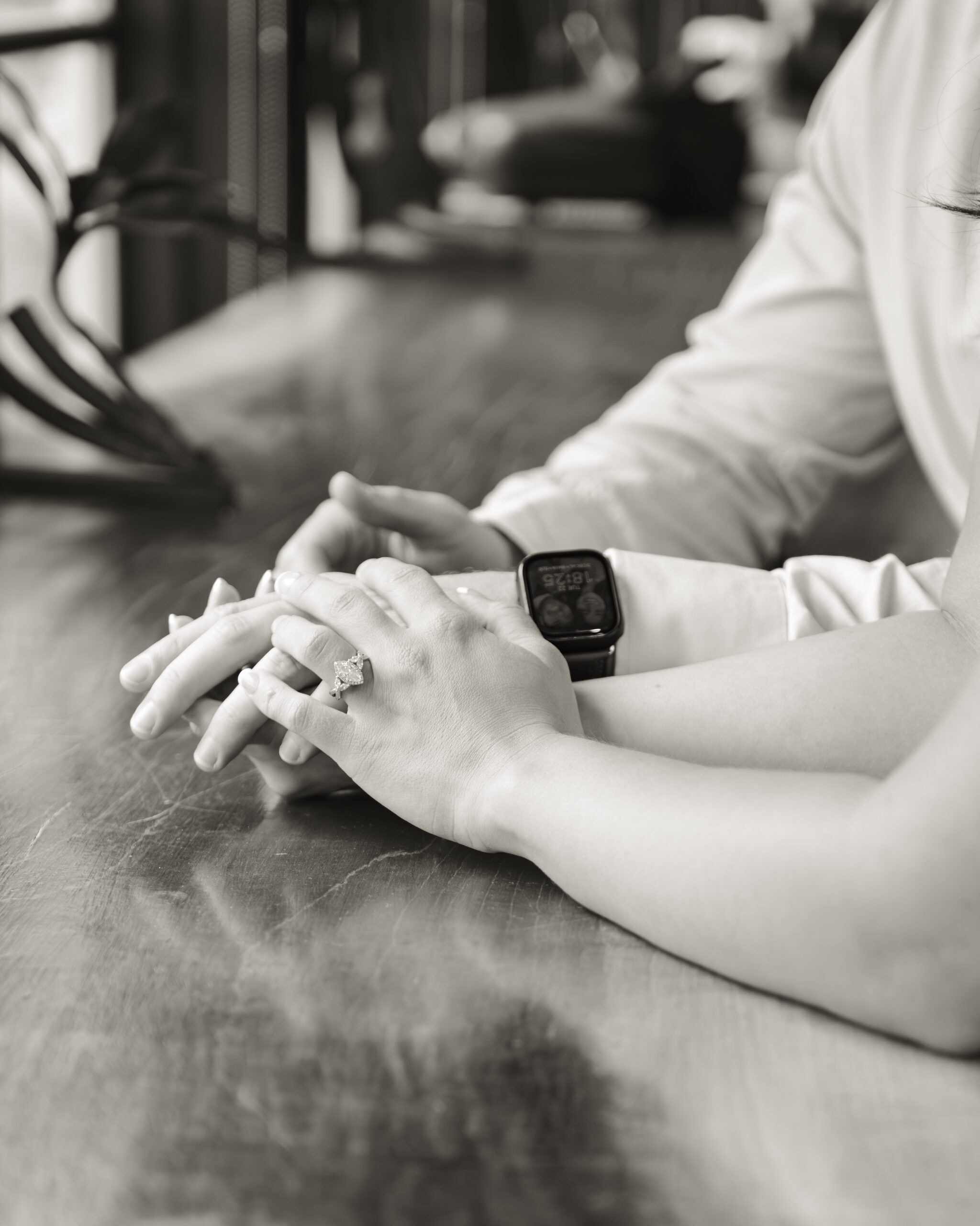 A black and white image of a catholic couple holding hands in a thompson's station coffee house sets a romantic tone for the gallery