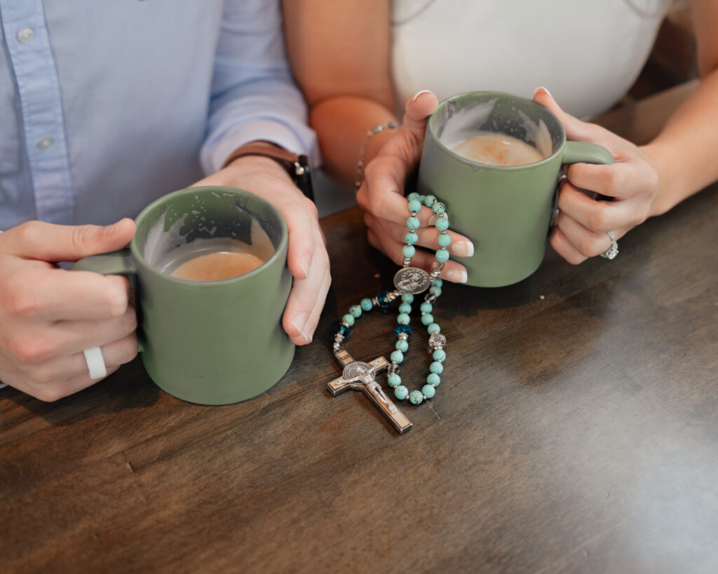 a detail image shows a catholic couple holding two coffee mugs and a gifted rosary, incorporating meaningful objects into their session