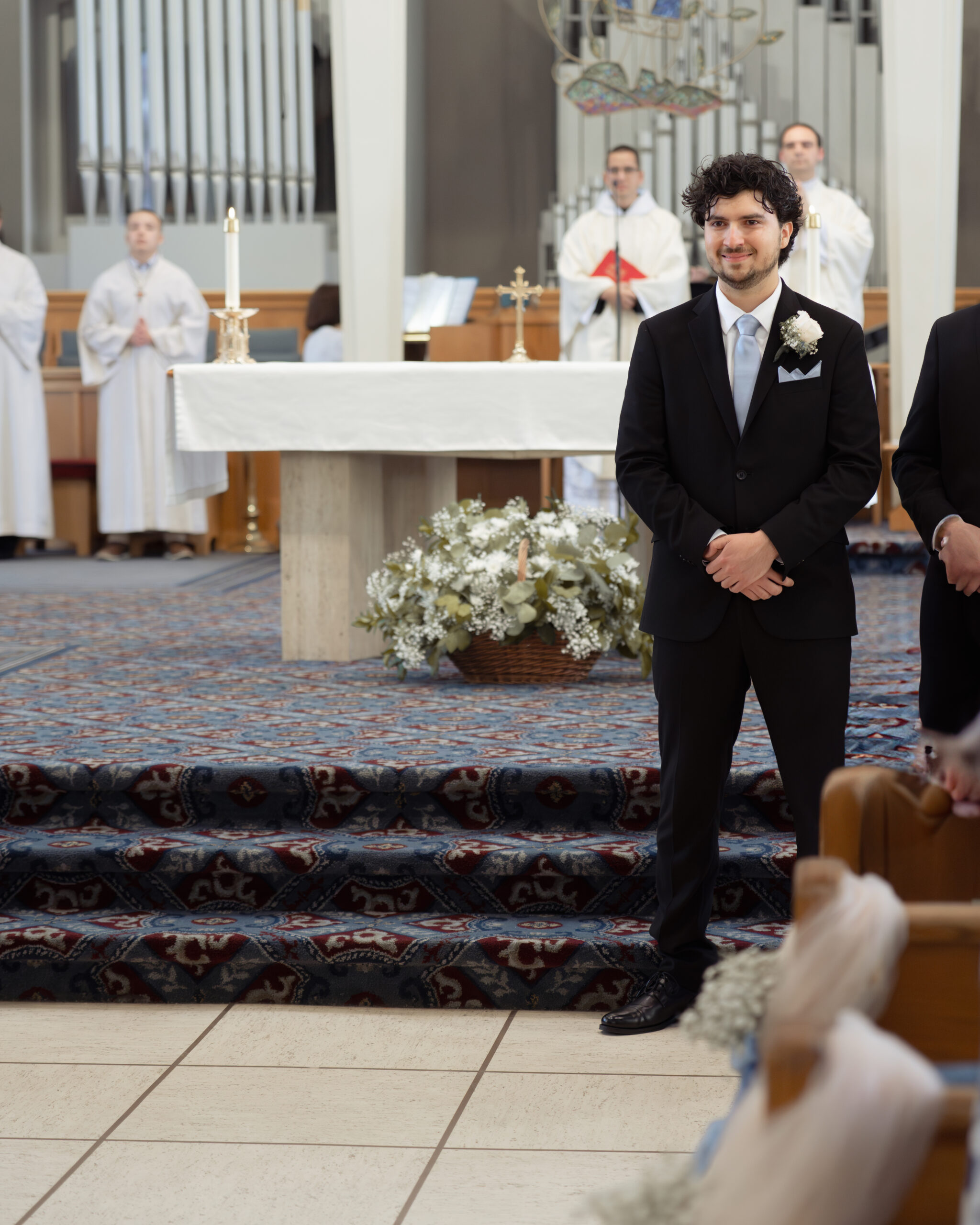 A catholic groom tearfully waits for his bride to walk down the aisle to him at holy spirit catholic church in Huntsville, alabama