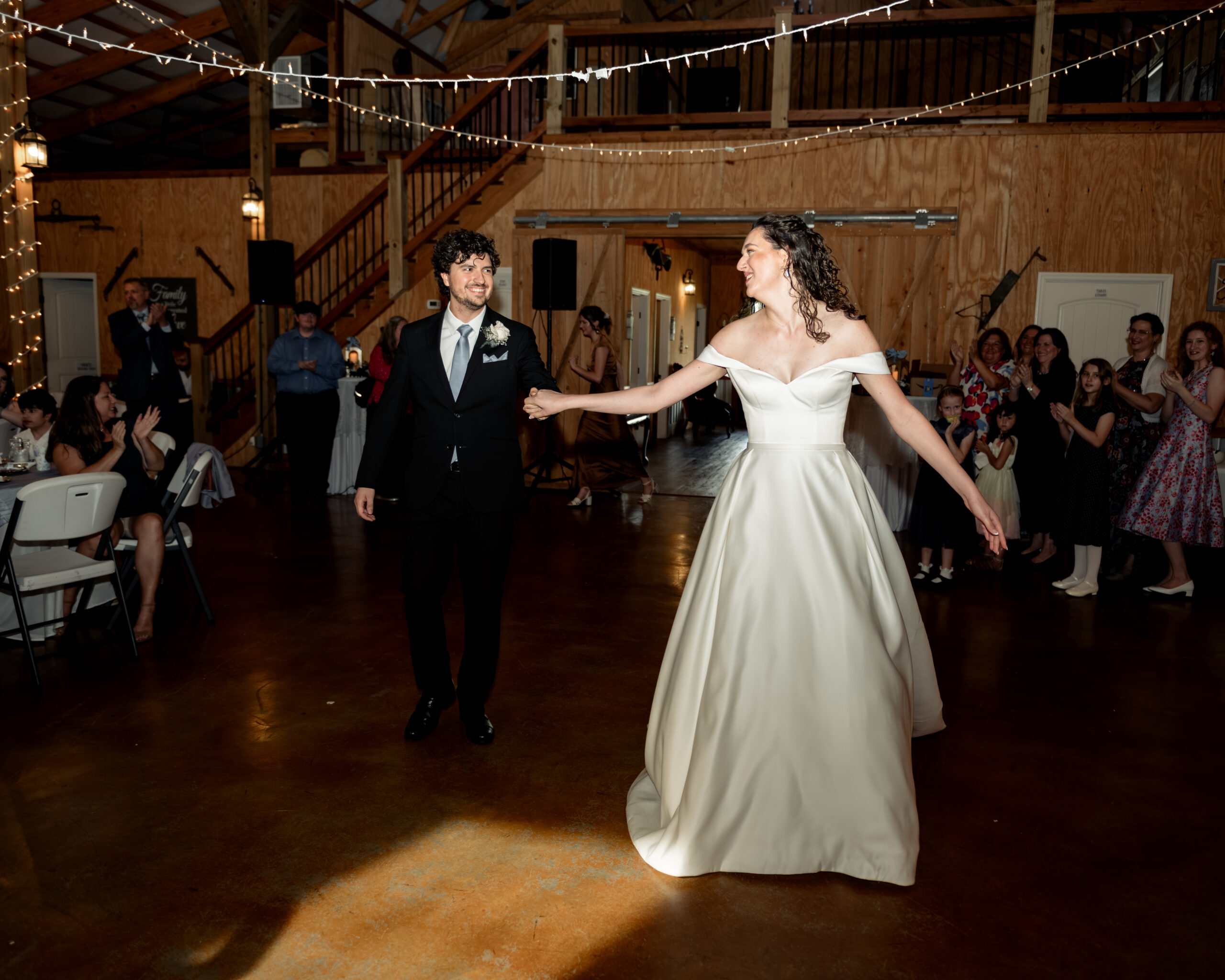 a catholic bride and groom joyfully enter their wedding reception at Southern Charm in Athens, alabama