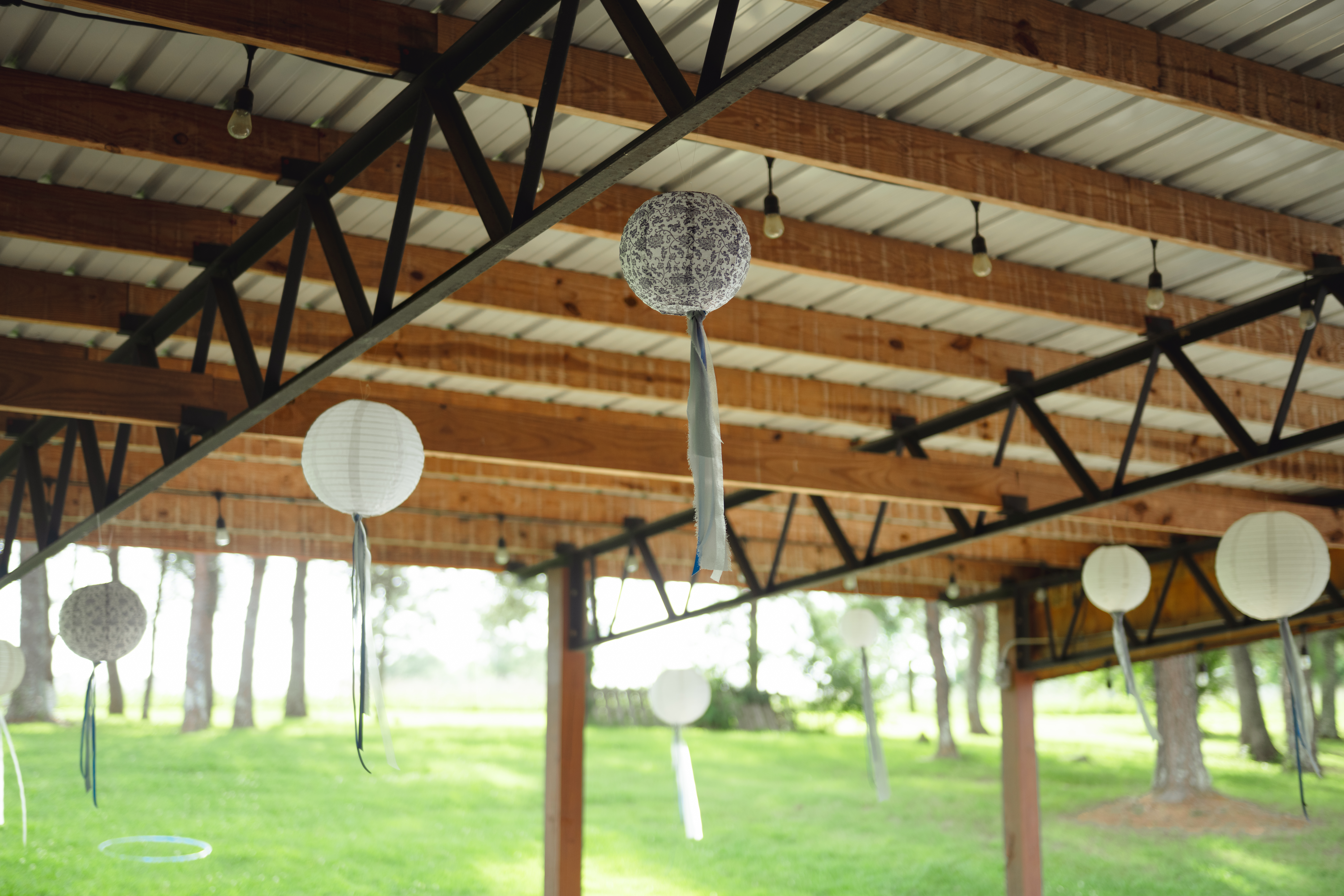 Paper lanterns decorate the reception space of a catholic wedding reception at Southern Charm in Athens, al