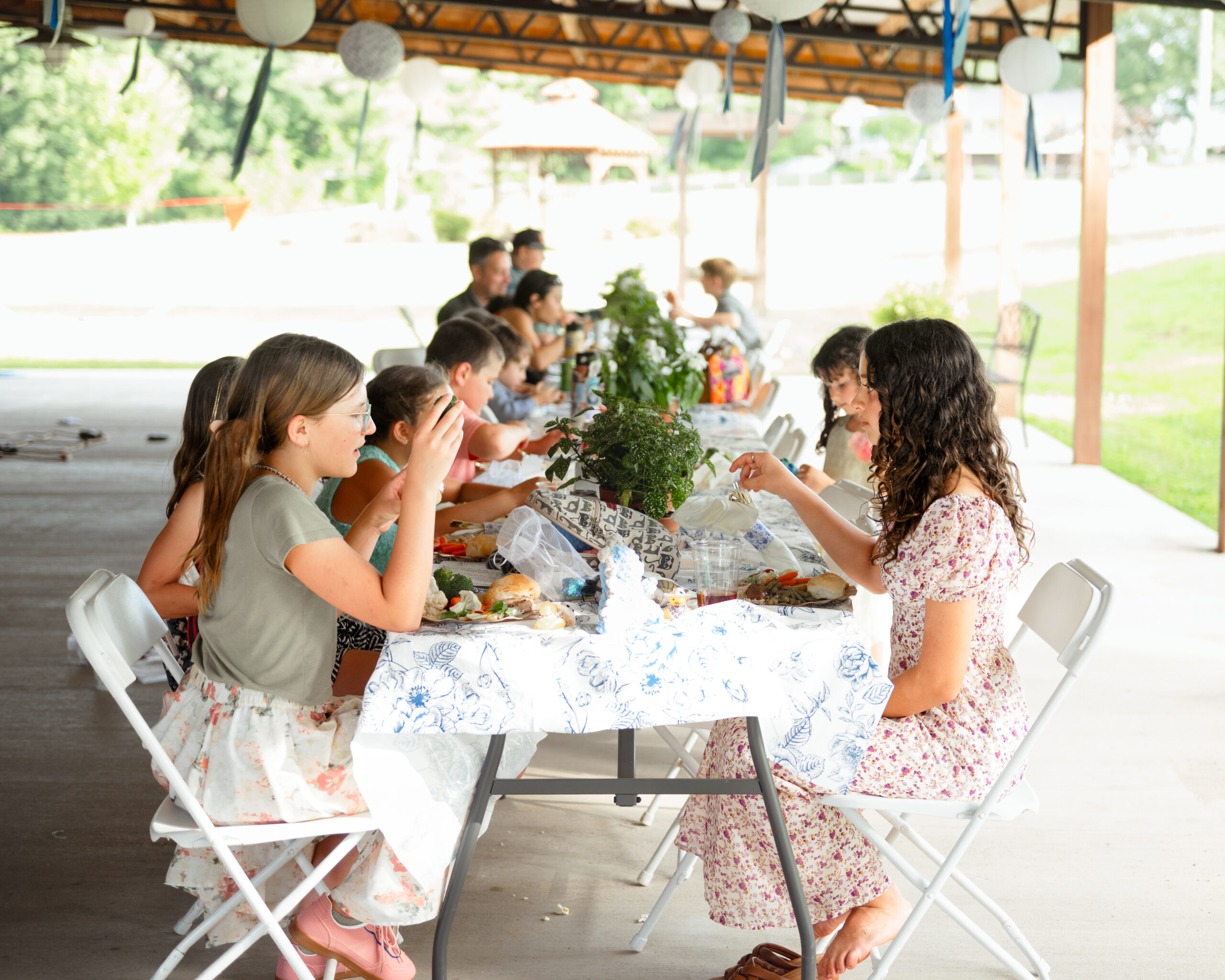 Children laugh and eat outside during a catholic wedding reception at southern charm in athens, al