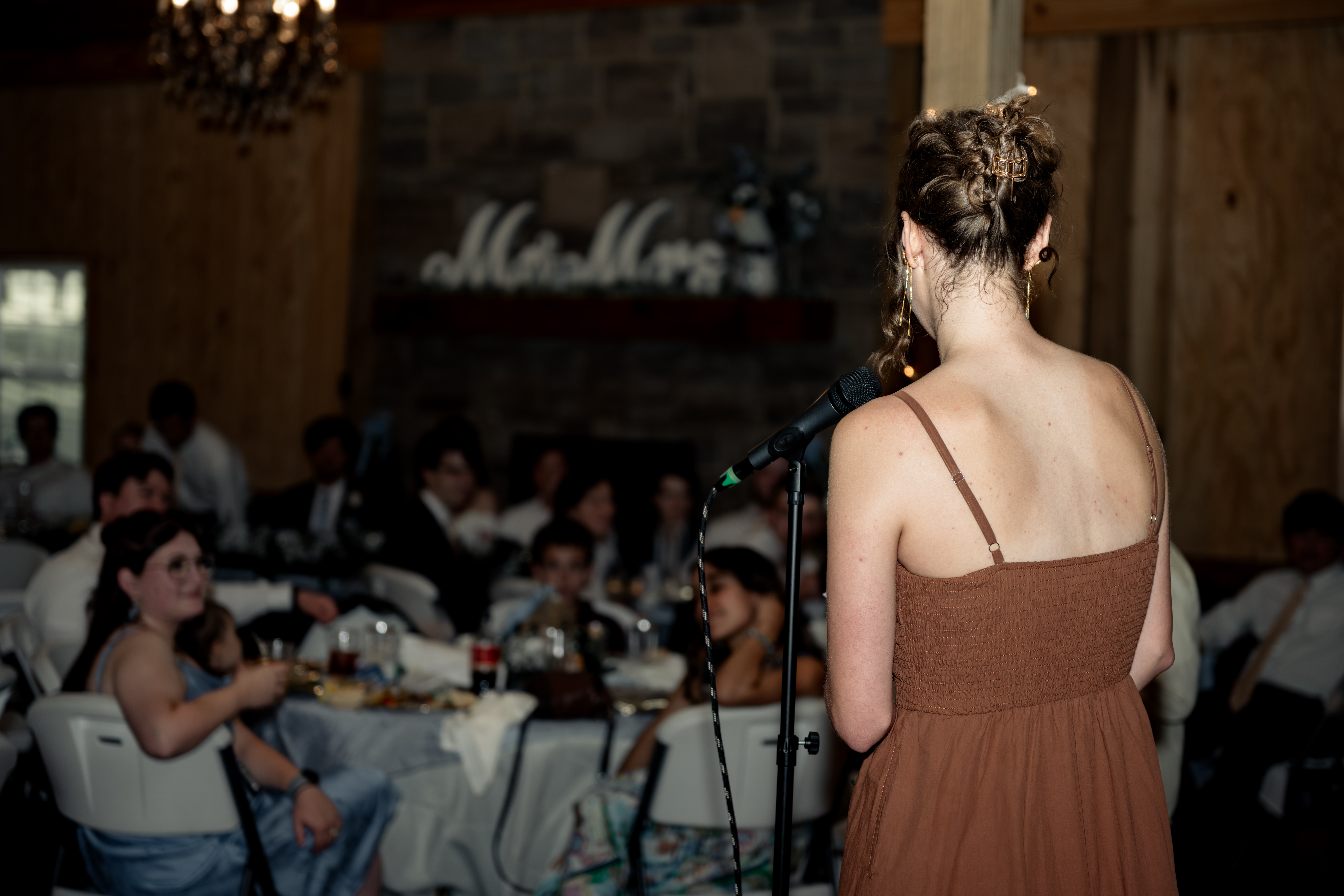 The maid of honor gives a toast during a large catholic wedding reception at southern charm in athens, alabama