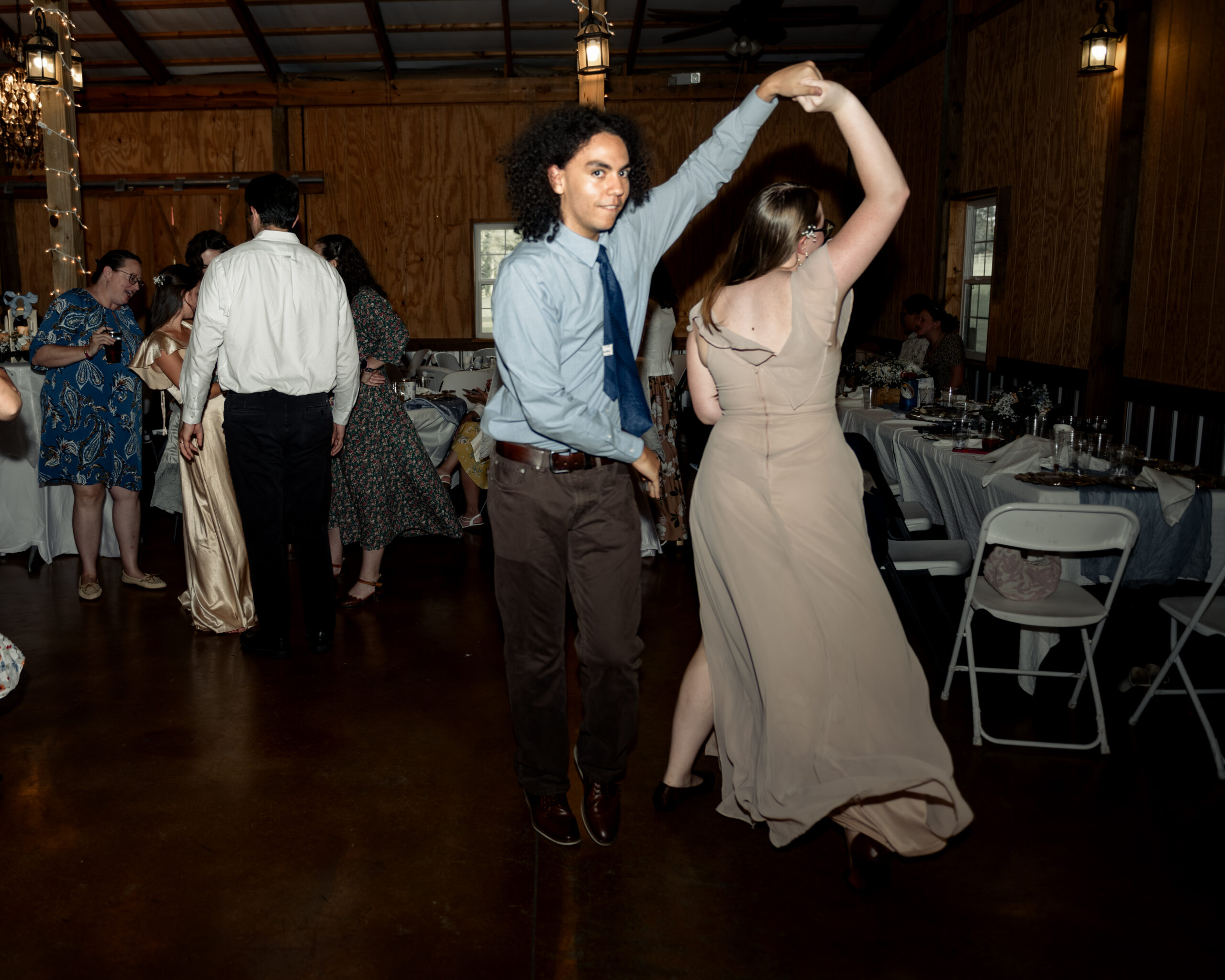 Guests enthusiastically dance at a large catholic wedding reception at southern charm in athens, alabama