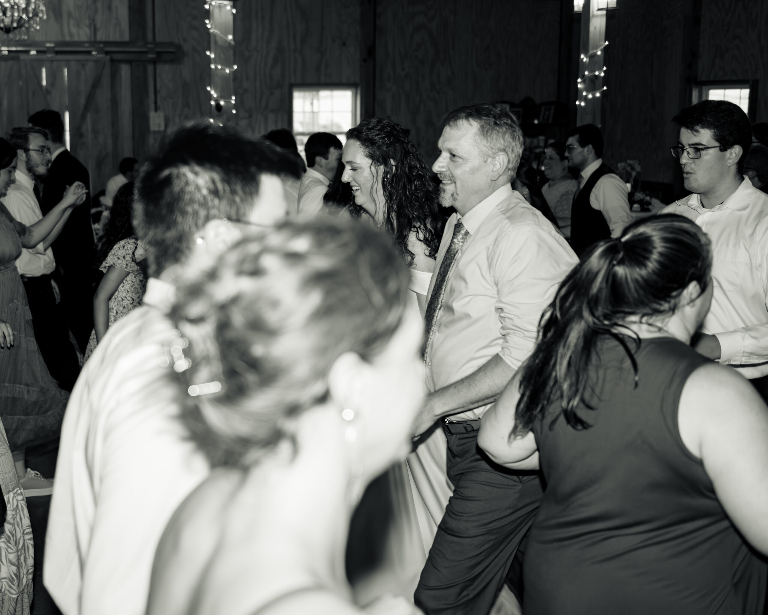 The bride dances with her father during a traditional line dance at a large catholic wedding reception at southern charm in athens, alabama