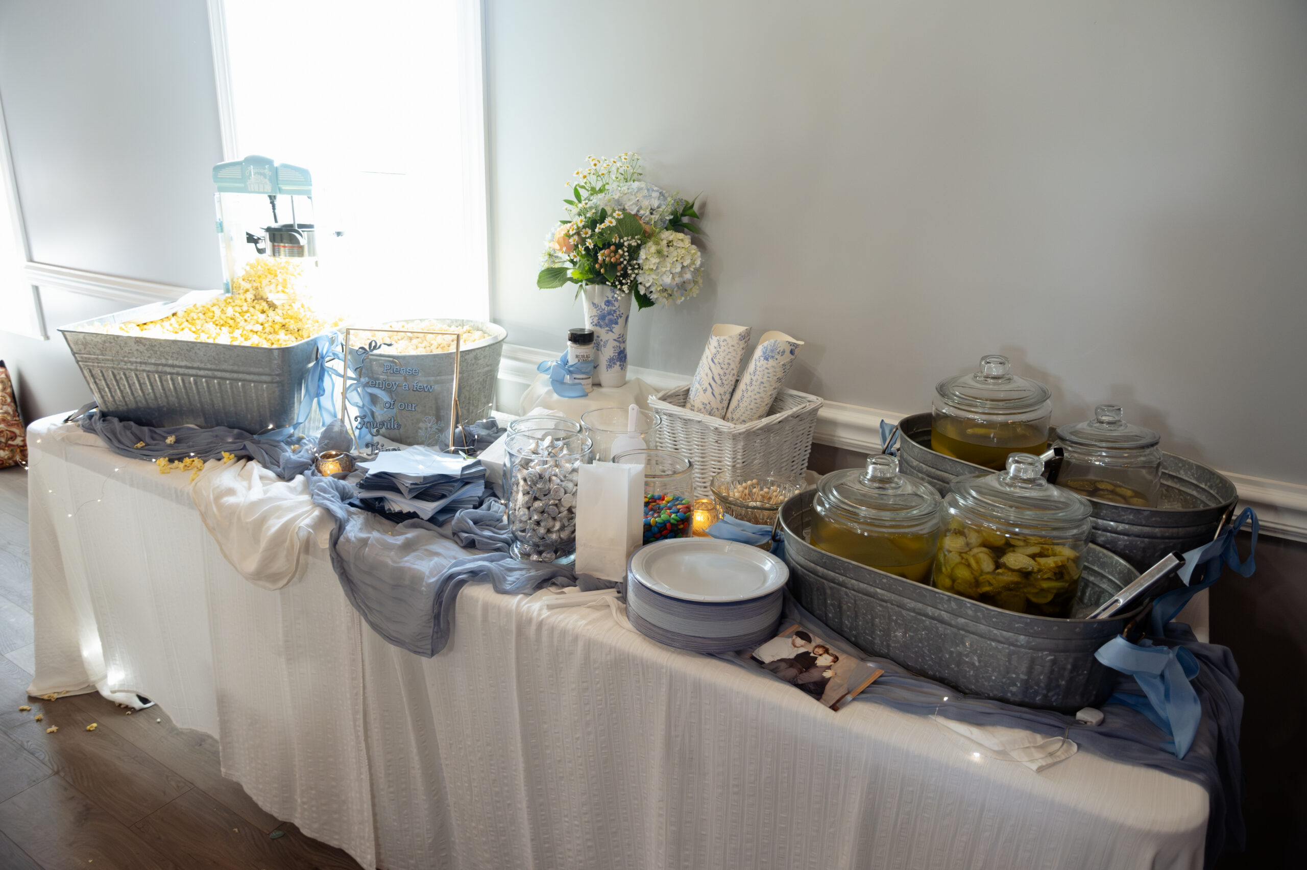 snacks sit on a table at southern charm in athens, al during a large catholic wedding reception
