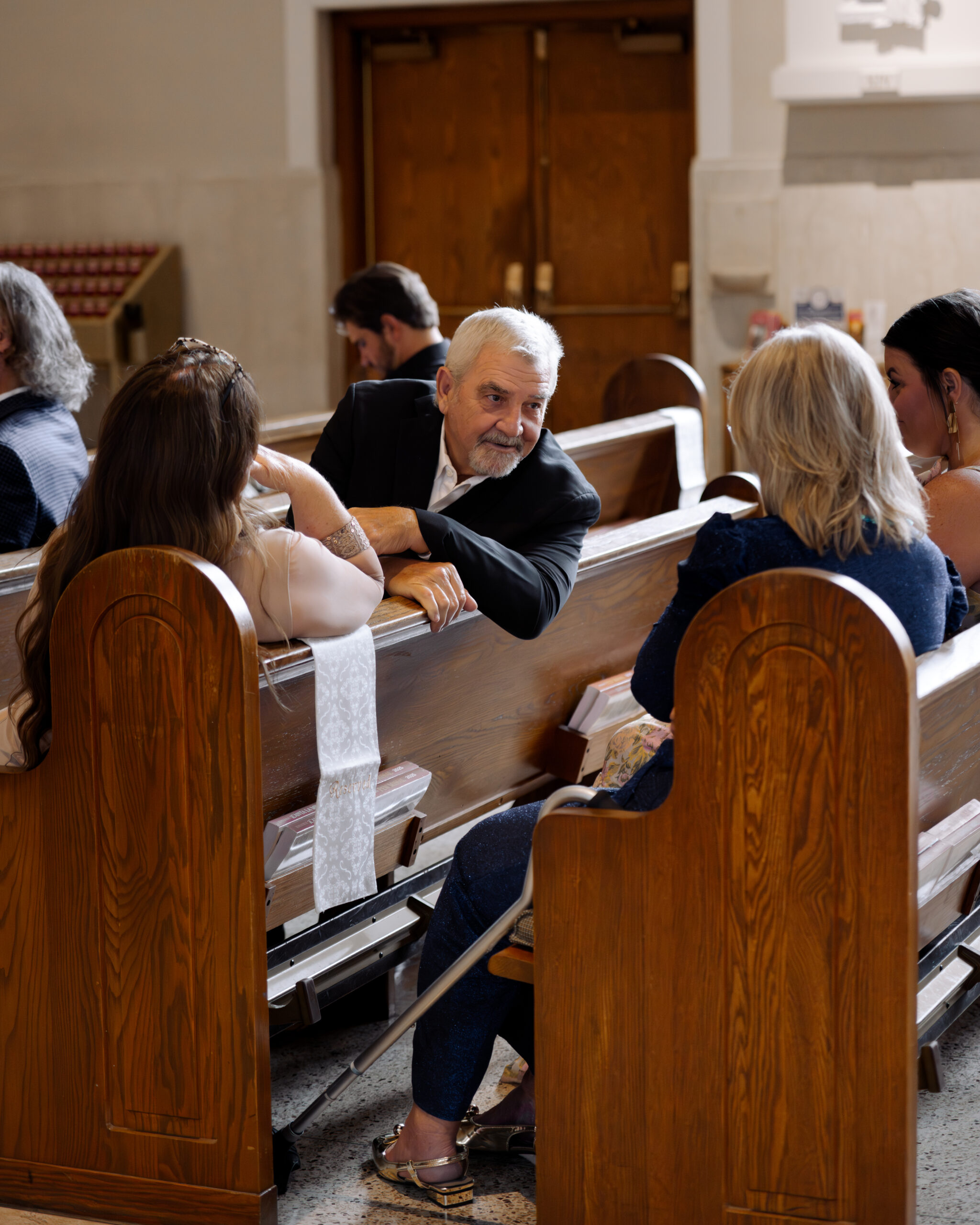 Wedding guests mingle in beautiful light at St. Ann's catholic church in nashville, TN