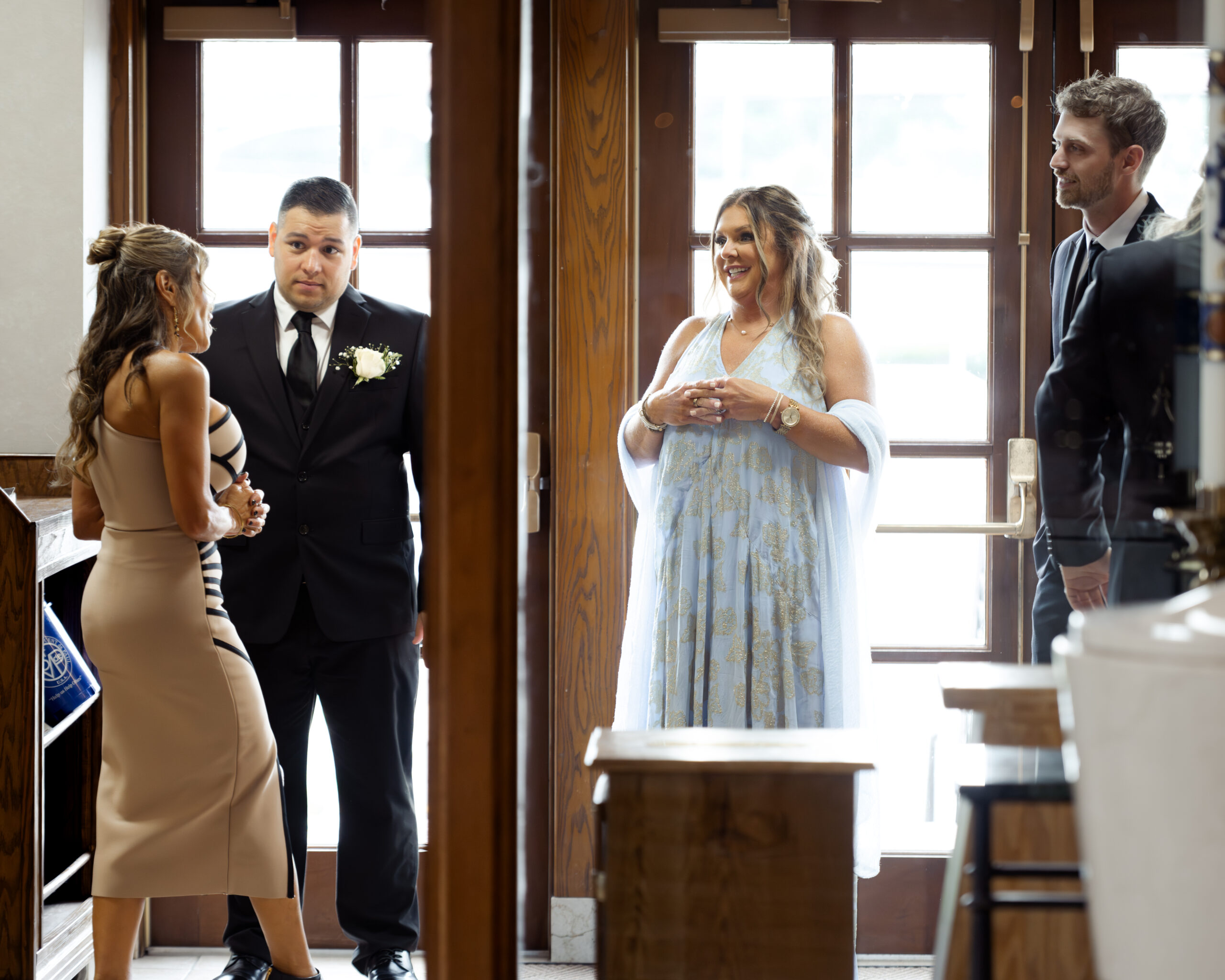 The family of the bride and groom wait in the narthex of St. Ann's catholic church in nashville, tN ahead of a catholic wedding ceremony