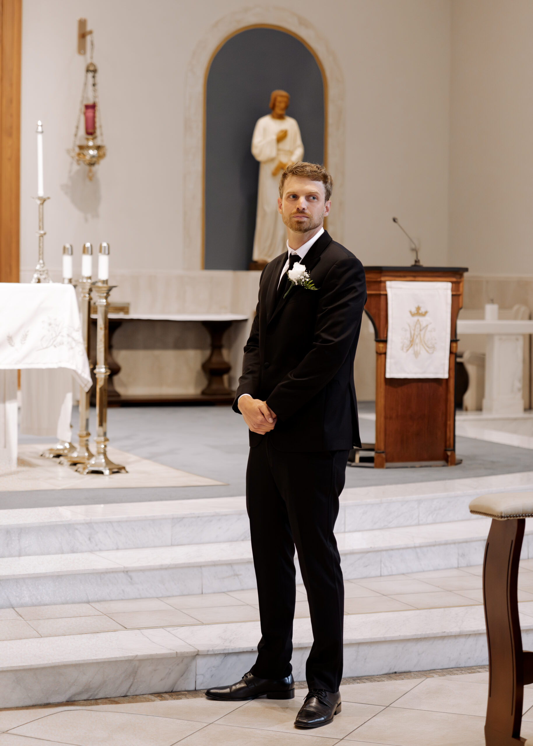 A groom tearfully watches his bride from the altar during a catholic wedding ceremony at St. Ann's Catholic Church in Nashville, TN